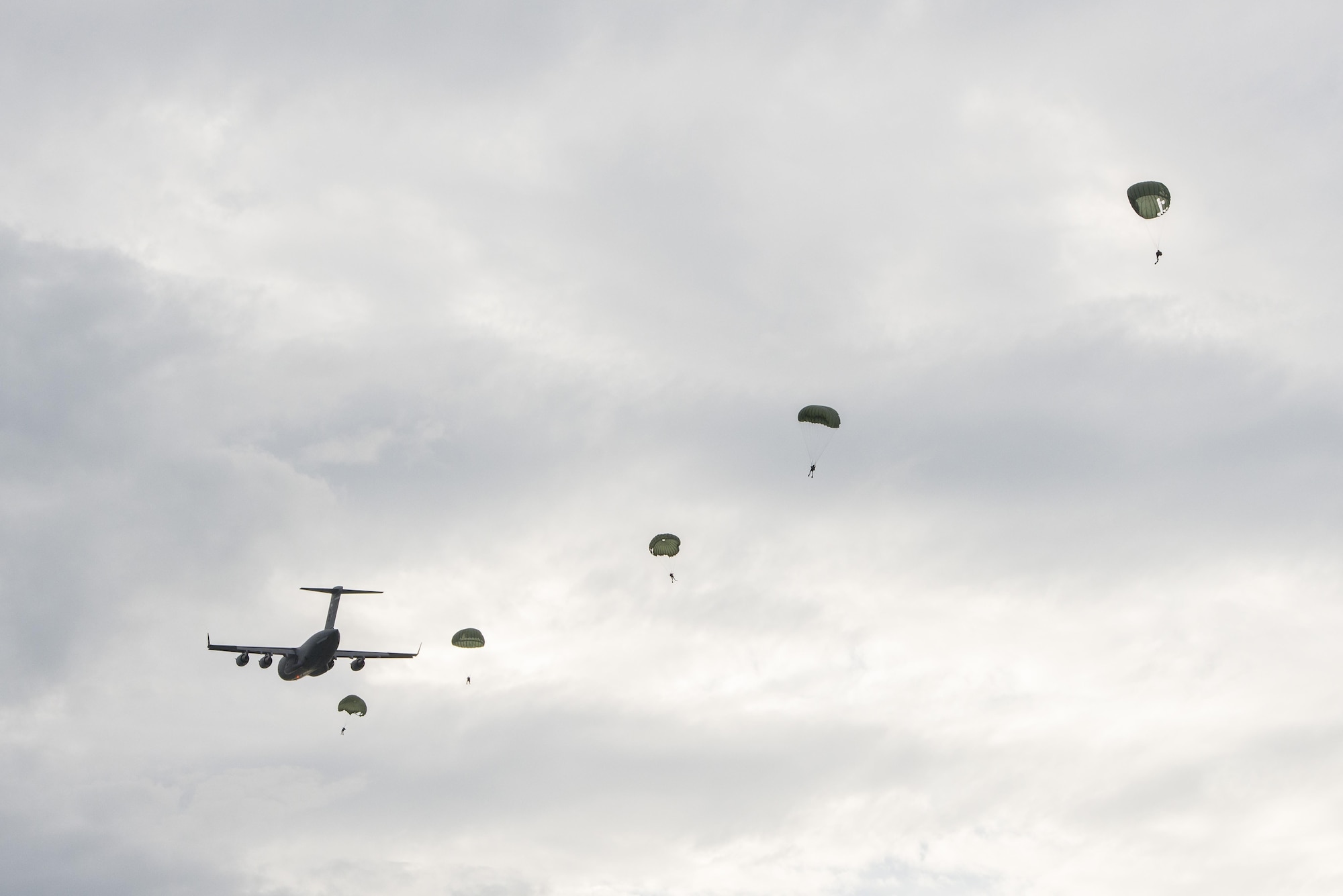 A C-17 Globemaster III from the Alaska Air National Guard�s 249th Airlift Squadron drops off paratroopers and equipment as part of an astronaut rescue exercise in the Atlantic Ocean near Cape Canaveral Air Force Station, Fla., Jan. 14, 2016. The 45th Operations Group�s Detachment 3 joined NASA's Commercial Crew Program, Air Force Reserve pararescuemen, combat rescue officers, and survival, evasion, resistance and escape specialists to practice recovering astronauts quickly and safely in the event they would need to abort their spacecraft. (U.S Air Force photo/Matthew Jurgens)