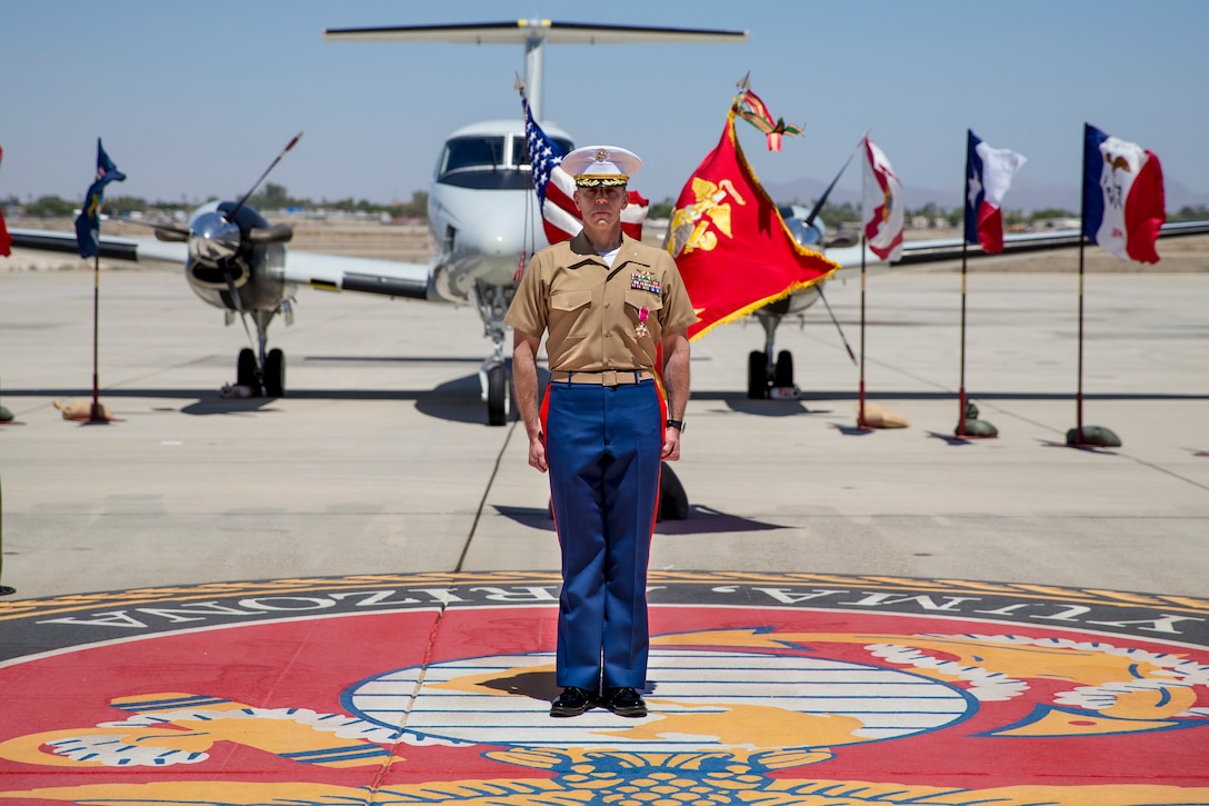 U.S. Marine Corps Lt. Col. Olgierd J. Weiss III stands at attention while Anchors Away and the Marine Corps Hymn are played during a retirement ceremony at Marine Corps Air Station Yuma, Ariz. May 21, 2021.