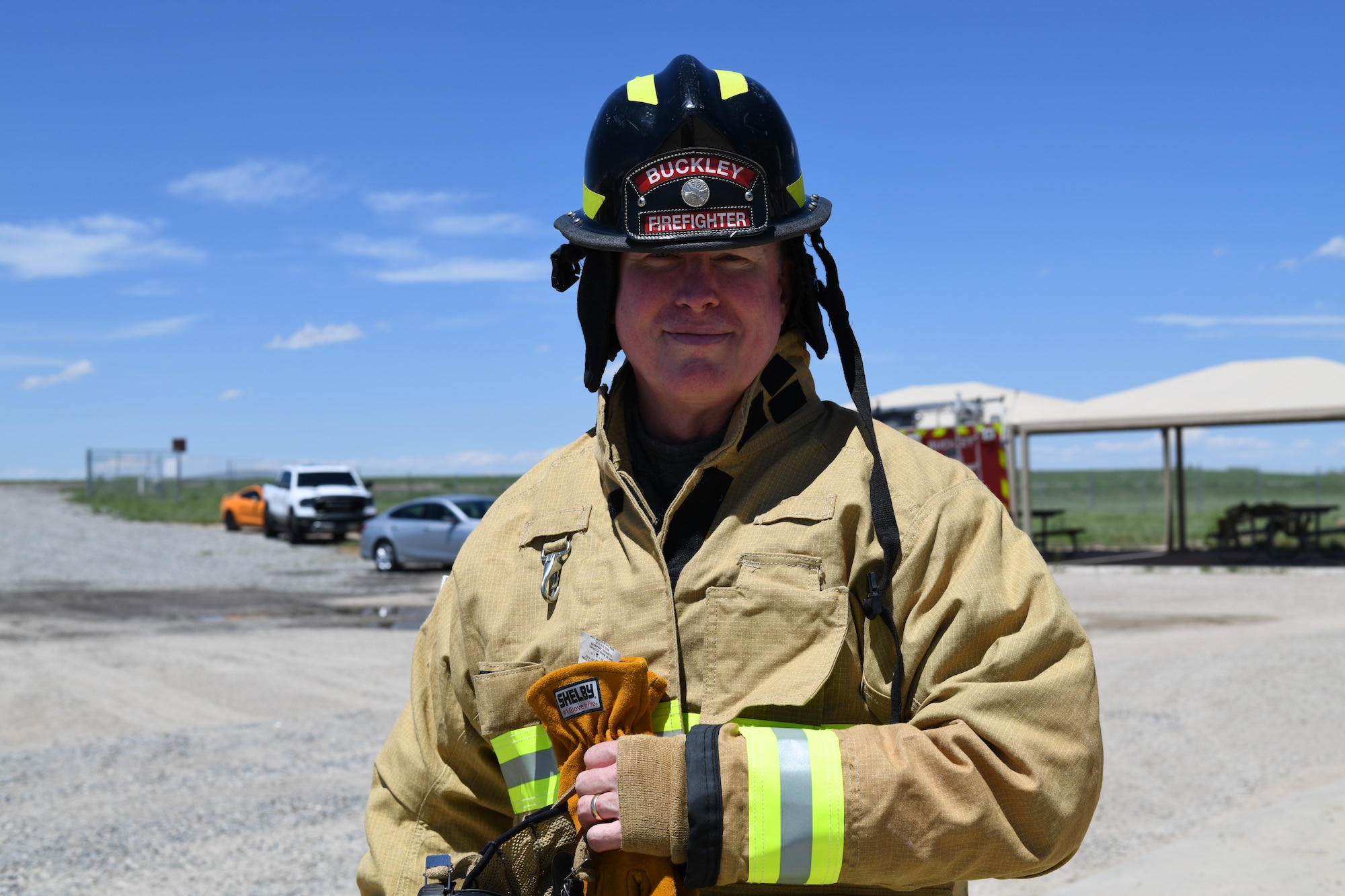 Lt. Col. Michael Hall, Buckley Garrison Inspector General, prepares for a fire exercise, May 25, 2021, on Buckley Air Force Base, Colo. The Buckley Fire Department showed Buckley Garrison leadership what their duties may entail with a simulated two-story fire exercise. (U.S. Space Force photo by Senior Airman Michael D. Mathews)