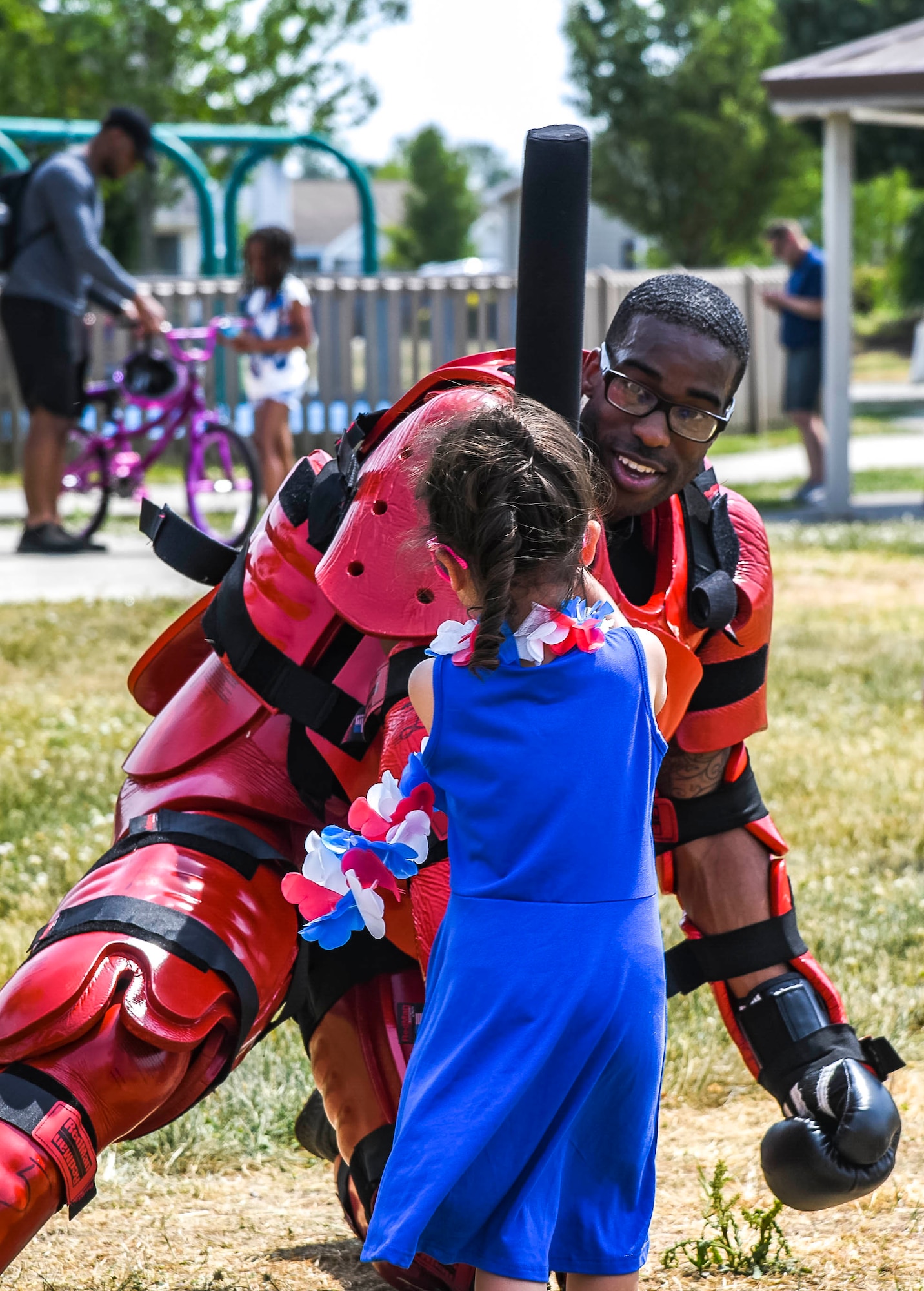 A child swings a baton at Staff Sgt. Ronald Cole, 436th Security Forces Squadron Raven, as part of a Ravens demonstration during the Bicycle Rodeo at Dover Air Force Base, Delaware, May 22, 2021. Children utilized the same training batons security forces members use to simulate hand-to-hand combat with suspects. (U.S. Air Force photo by Airman 1st Class Stephani Barge)