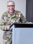 Woman in military uniform behind podium.