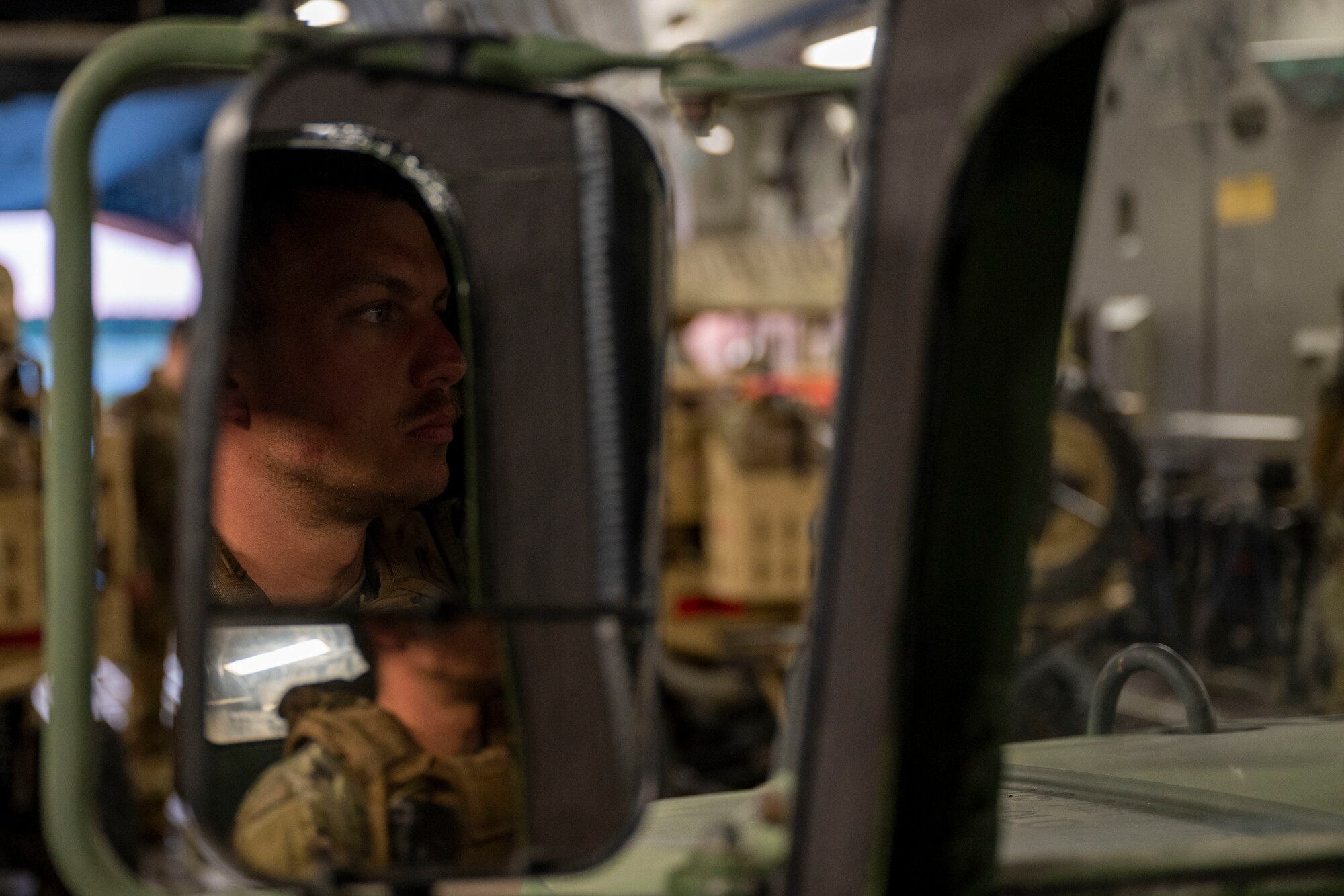 U.S. Air Force Staff Sgt. Steven Smallcombe, 321st Contingency Response Squadron close precision engagement team member, sits in a Humvee on the back of a C-17 Globemaster III before taking off during Exercise Mobility Guardian 2021 at Alpena Combat Readiness Training Center, Michigan, May 24, 2021. Throughout Exercise Mobility Guardian, this highly-specialized team provided critical joint all-domain command and control support as well as security to simulated austere airfields. (U.S. Air Force photo by Senior Airman Aaron Irvin)