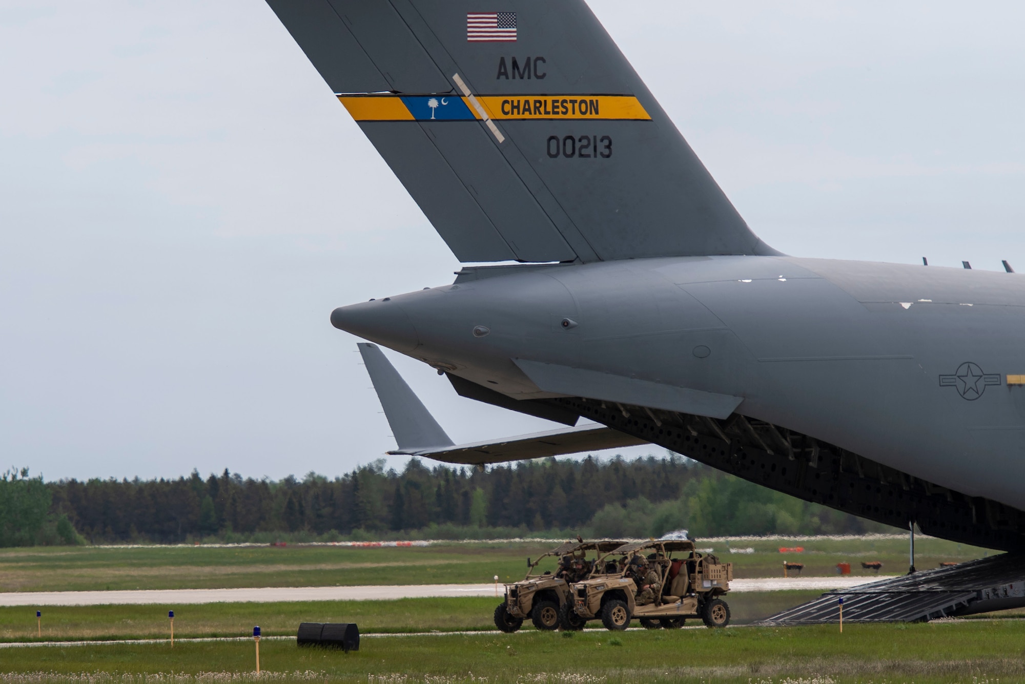 U.S. Airmen from the 321st Contingency Response Squadron drive an MRZR all-terrain vehicle off the back of a C-17 Globemaster III at Alpena Combat Readiness Training Center, Michigan, May 24, 2021, in support of Exercise Mobility Guardian 2021. Mobility Guardian 2021 includes Air Mobility Command’s first large-scale training on Agile Combat Employment. (U.S. Air Force photo by Senior Airman Aaron Irvin)