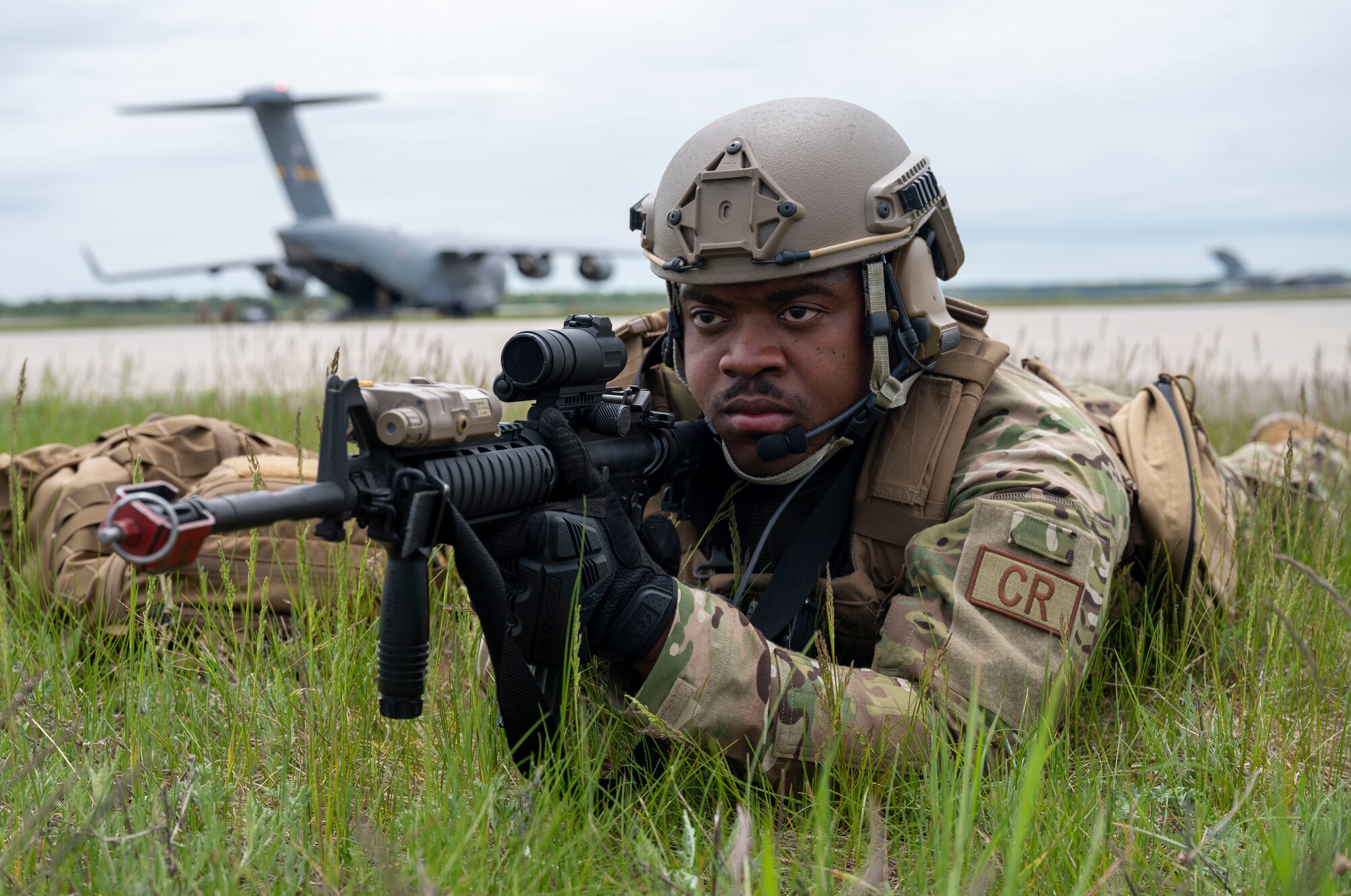 U.S. Air Force Senior Airman Nyle Winston, 321st Contingency Response Squadron security team member, secures a refueling area at Alpena Combat Readiness Training Center, Michigan, May 24, 2021, in support of Exercise Mobility Guardian 2021. Mobility Guardian tests Mobility Airmen through a challenging, realistic and detailed scenario based on relevant real-world security challenges. (U.S. Air Force photo by Senior Airman Aaron Irvin)