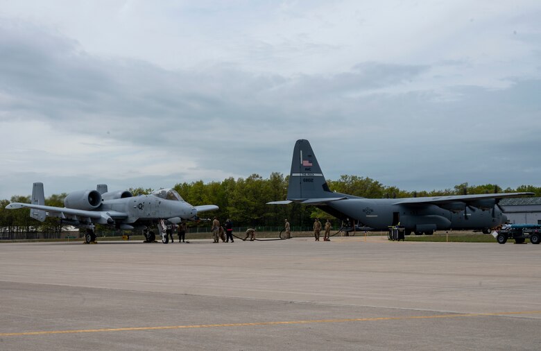 Airmen fuel an A-10 Thunderbolt II using an Aerial Bulk Fuel Delivery System out the back of a C-130J Super Hercules at Alpena Combat Readiness Training Center, Michigan, May 24, 2021, in support of Exercise Mobility Guardian 2021. The ABFDS, a portable 3,000-gallon fuel bladder, can be loaded on a C-130J Super Hercules, C-5 Galaxy, or C-17 Globemaster III and transported anywhere around the world. (U.S. Air Force photo by Senior Airman Aaron Irvin)