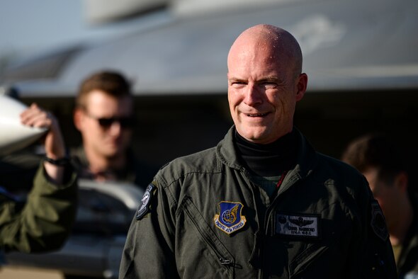 A commander smiles after his final flight.