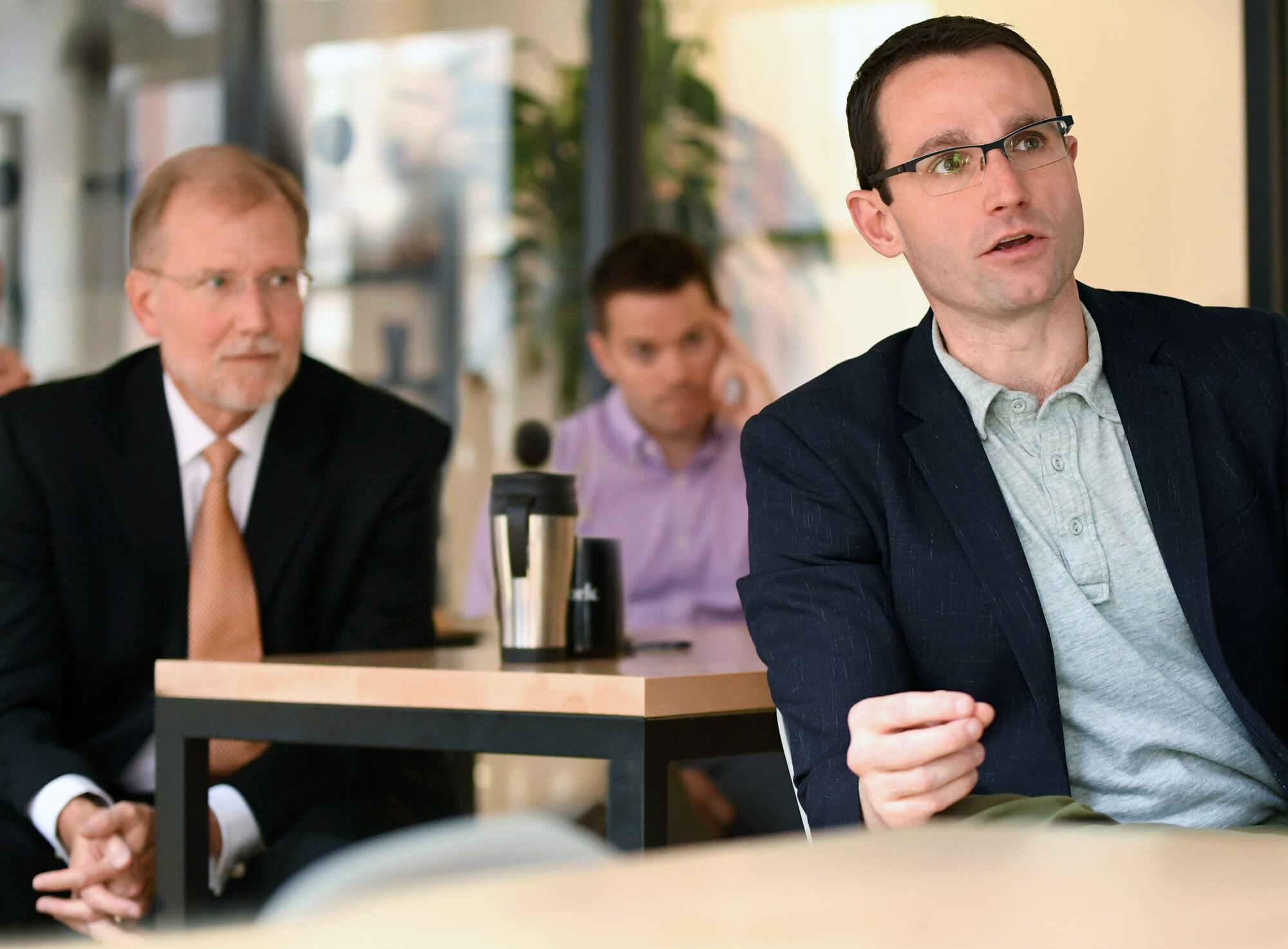 Assistant Secretary of the Air Force for Acquisition, Technology and Logistics Dr. Will Roper, right, looks on with Steven Wert, Battle Management program executive officer, Air Force Life Cycle Management Center at Hanscom Air Force Base, Mass., during a presentation at Project Kessel Run in the WeWork shared space in Boston July 30. Roper and Wert visited the site to hear how Airmen, contractors and civilians are writing custom software applications for use at Air Operations Centers. (U.S. Air Force photo by Todd Maki)