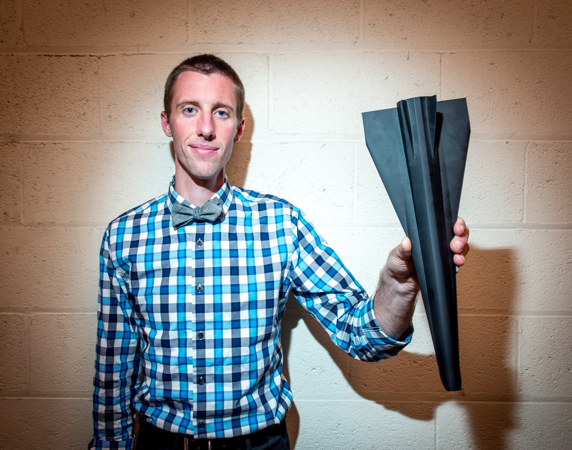 Ryan Helbach, a Hypersonic Research Engineer, holds a flight test model in Hypersonic Combustion Research Cell 22, used to research SCRAM jet technology at the Air Force Research Laboratory at Wright Patterson Air Force Base in Dayton, Ohio, Jul 21, 2016. Helbach is the program lead for AFRL's Intellect to Intellect Exchange (i2i Exchange) which pairs AFRL scientists and engineers with innovative private tech companies and created the AFRL Entrepreneurial Program allowing scientists and engineers to take sabbaticals to pursue outside for-profit goals. (U.S. Air Force photo by J.M. Eddins Jr.)