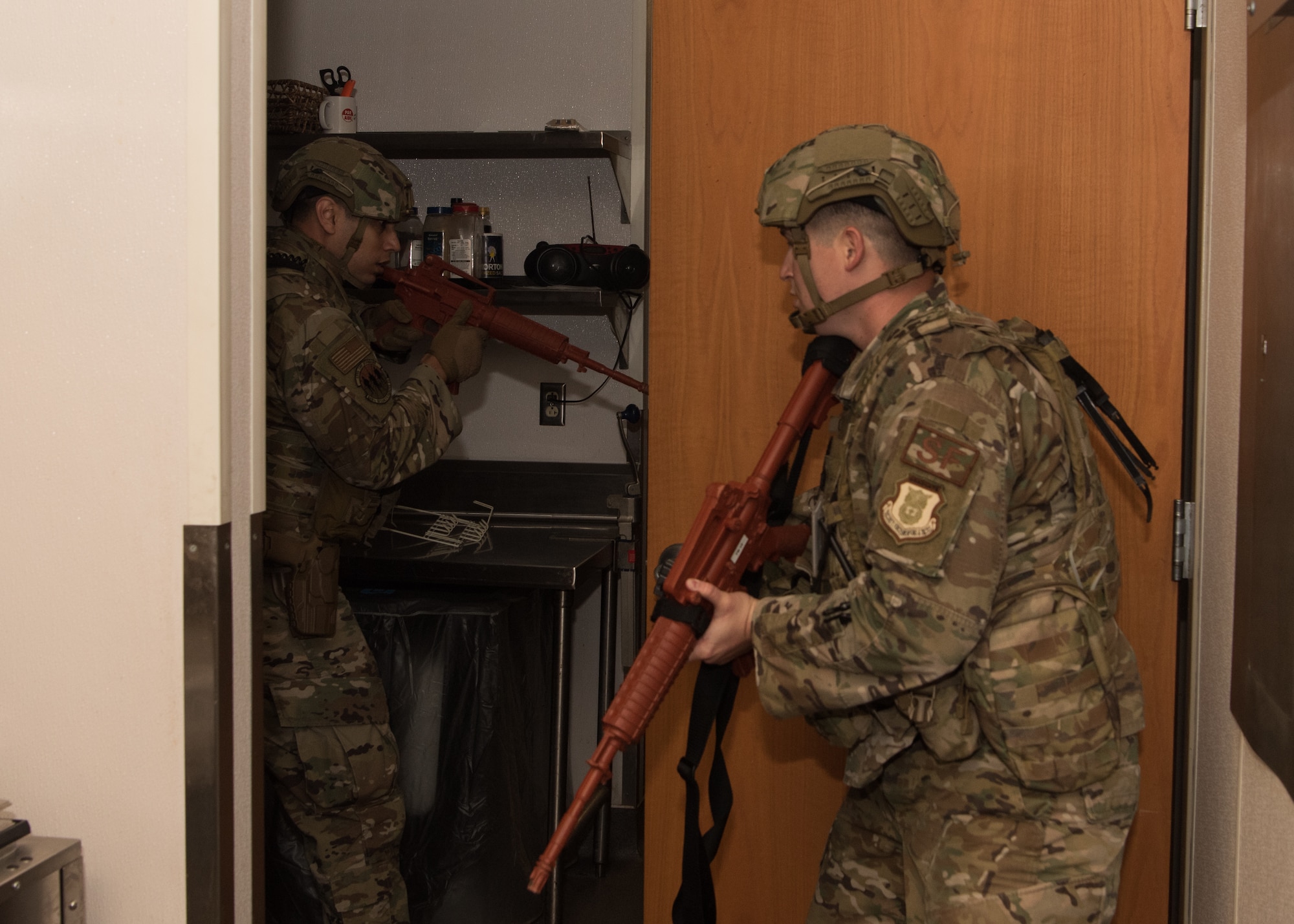 509th Security Forces Squadron Airmen clear rooms in the Royal Oaks Golf Course.