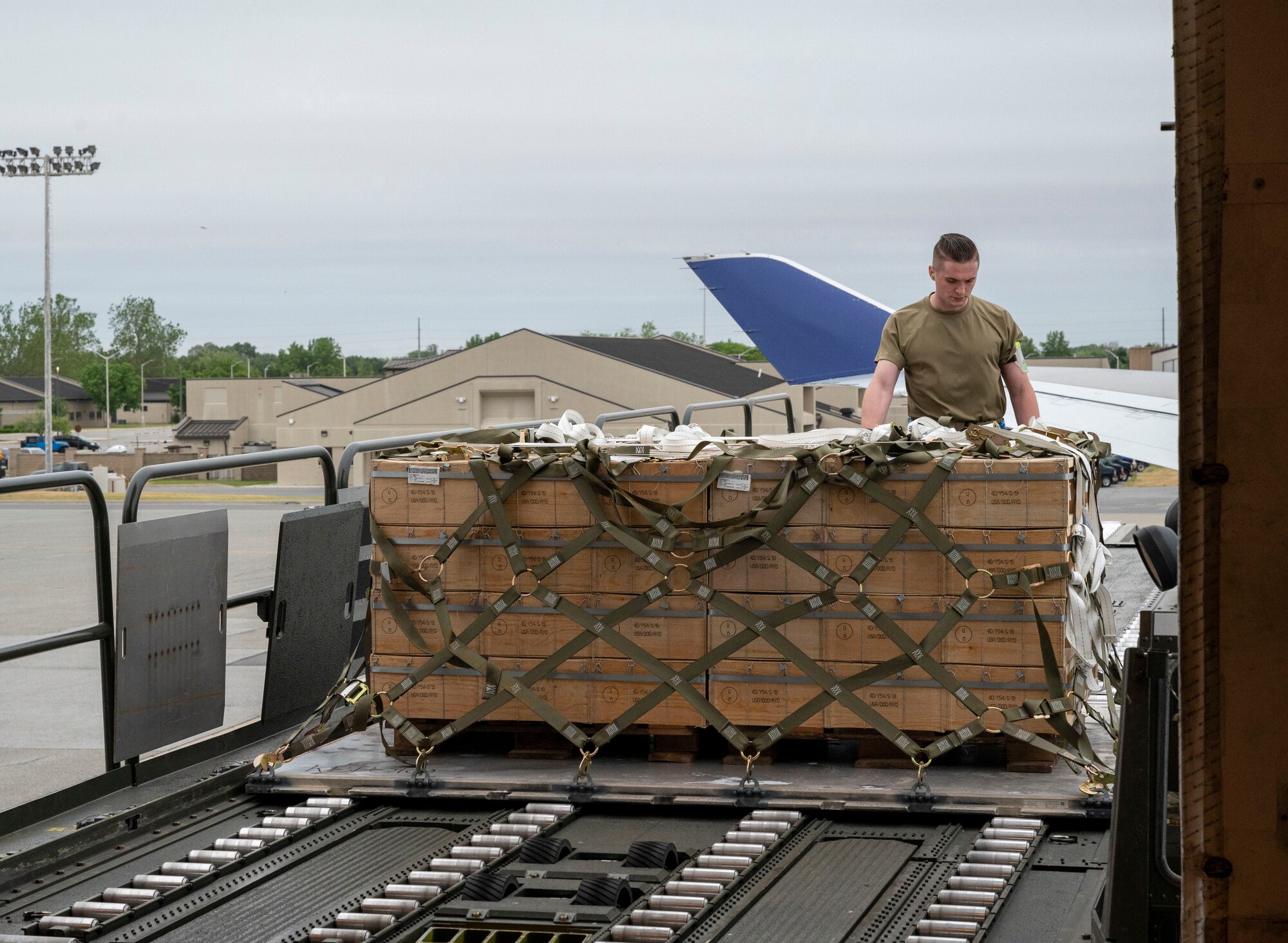 Senior Airman Ty Shaw, 436th Aerial Port Squadron ramp services specialist, guides cargo onto an aircraft in support of a security assistance mission between the U.S. and Ukraine at Dover Air Force Base, Delaware, May 24, 2021. The U.S. and Ukraine first initiated a partnership in 1993. Missions such as this demonstrate the U.S.’s commitment to Ukraine’s independence, sovereignty and territorial integrity. (U.S. Air Force photo by Airman 1st Class Cydney Lee)