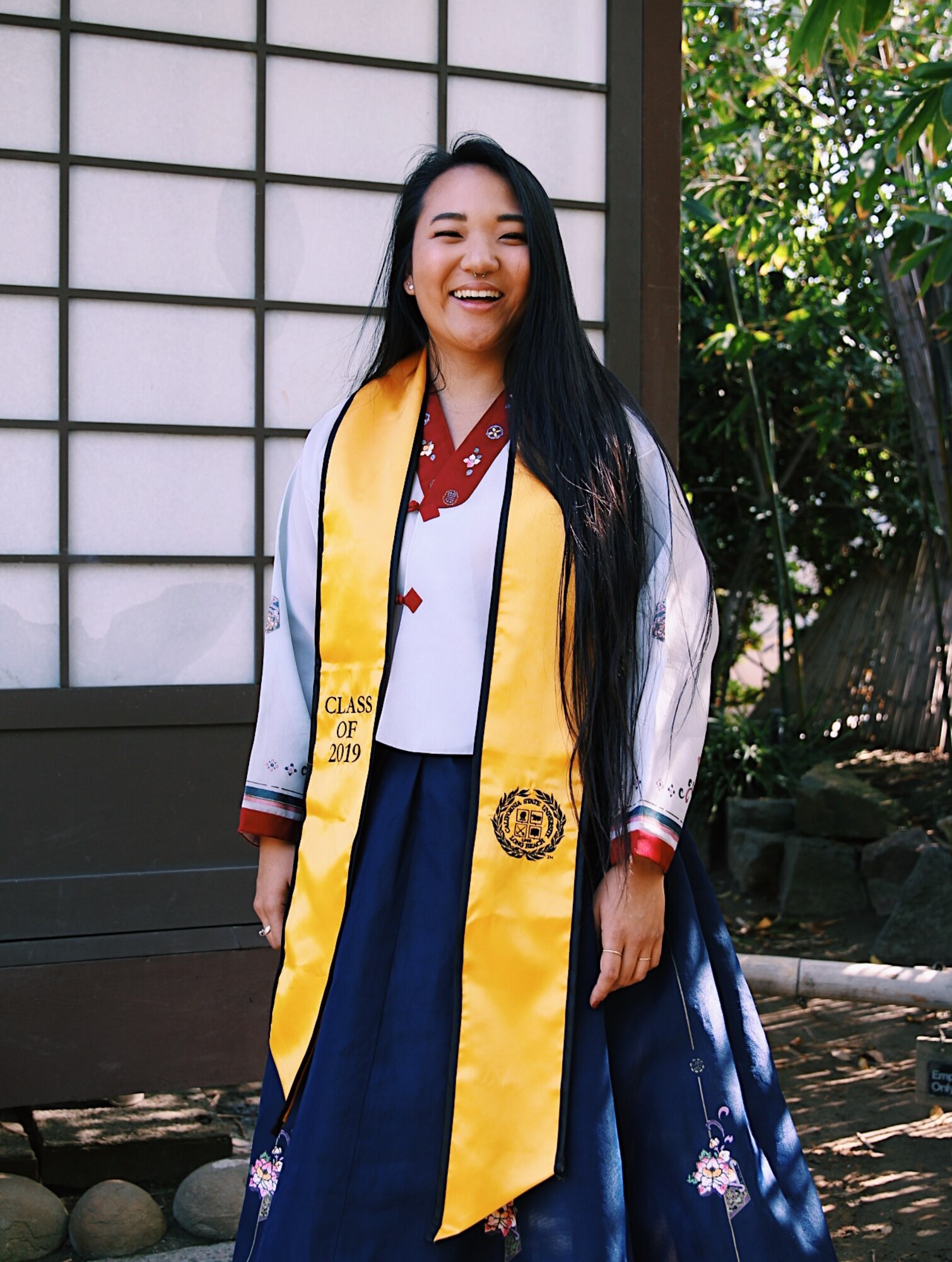 U.S. Air Force 2nd Lt. Michelle Chang, 92nd Air Refueling Wing public affairs command information chief, poses for a graduation photo, at California State University Long Beach, 10 May, 2019. Chang is wearing a hanbok, a traditional Korean dress, worn to represent her culture and heritage. (Courtesy photo)