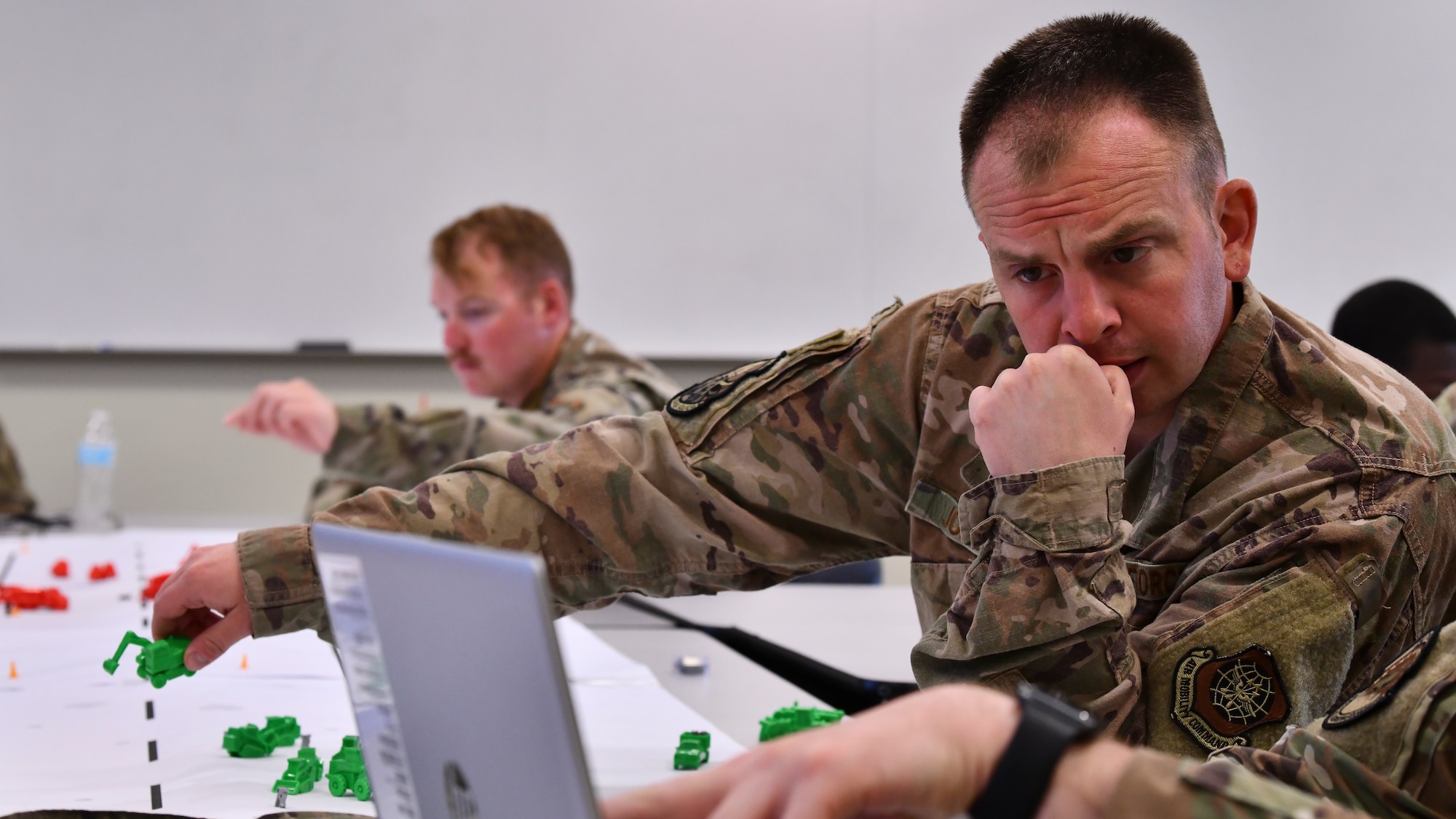 Staff Sgt. Allen Jones, an electrical systems journeyman assigned to the 436th Civil Engineering Squadron, and a teammate evaluate where to pit an excavator during a tabletop exercise at Alpena Combat Readiness Training Center, Mich., May 22, 2021. The purpose of the tabletop exercise was to familiarize civil engineering Airmen with the Rapid Airfield Deployment Recovery program and introduce them to scenarios from a leadership perspective during Exercise Mobility Guardian 2021. Mobility Guardian provides a realistic training environment for more than 1,800 Mobility Airmen to hone their skills in delivering rapid global mobility in current and future conflicts. (U.S. Air Force photo by Tech. Sgt. Kentavist P. Brackin)