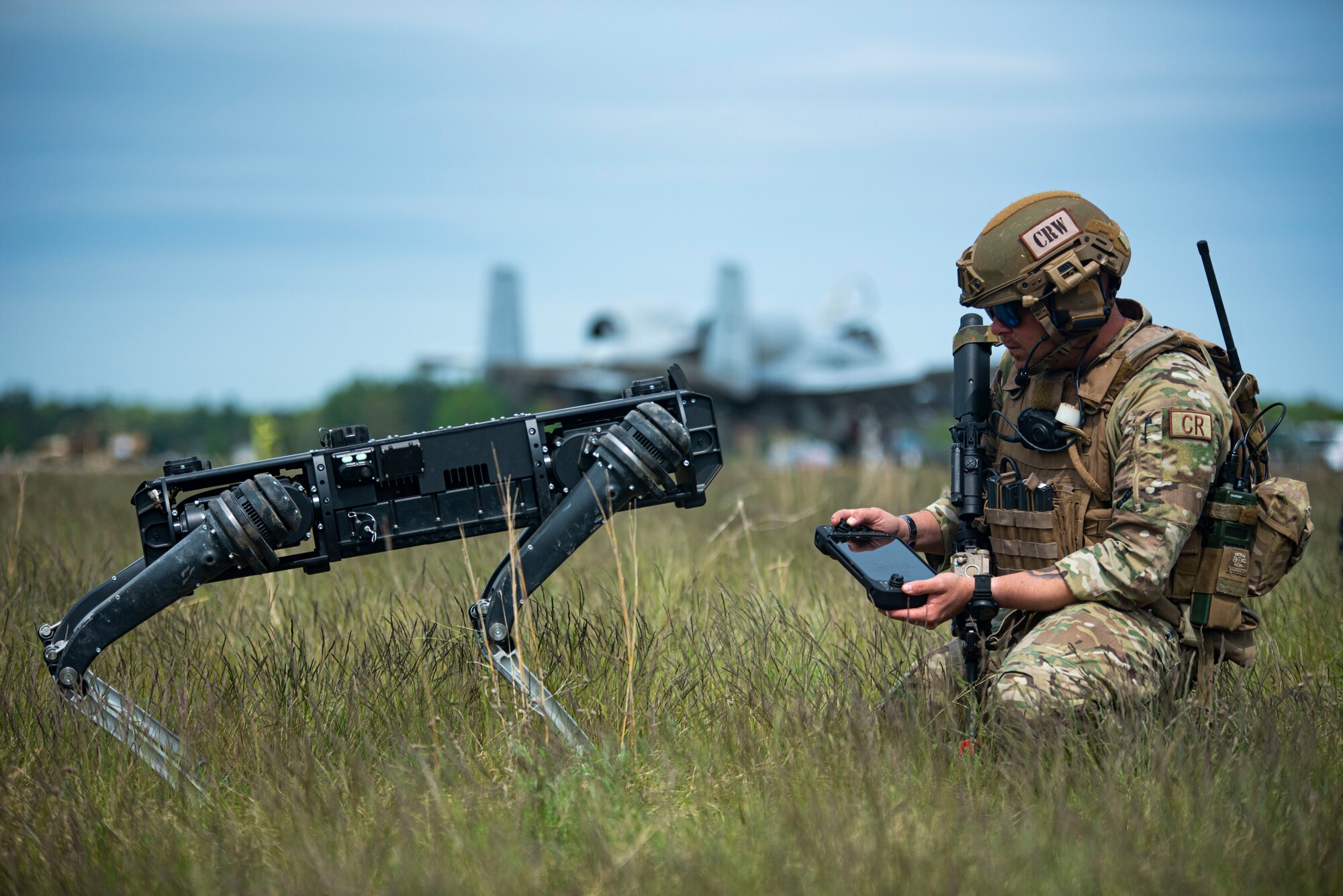 Tech. Sgt. Lance Oakes, 621st Contingency Response Squadron fire team lead, activates a semi-autonomous quadrupedal unmanned ground vehicle during Exercise Mobility Guardian at Alpena Combat Readiness Training Center, Michigan, May 22, 2021. Mobility Guardian is a training exercise designed to prepare Airmen to face real-world security challenges and sustain strategic deterrence anywhere in the world. (U.S. Air Force photo by Airman 1st Class Matthew Porter)