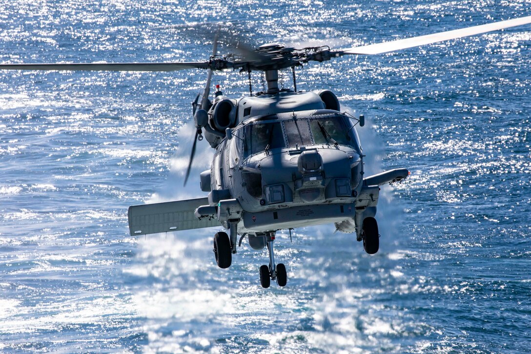 An MH-60R Sea Hawk, assigned to the “Spartans” of Helicopter Maritime Strike (HSM) Squadron 70, flies over the Atlantic Ocean.