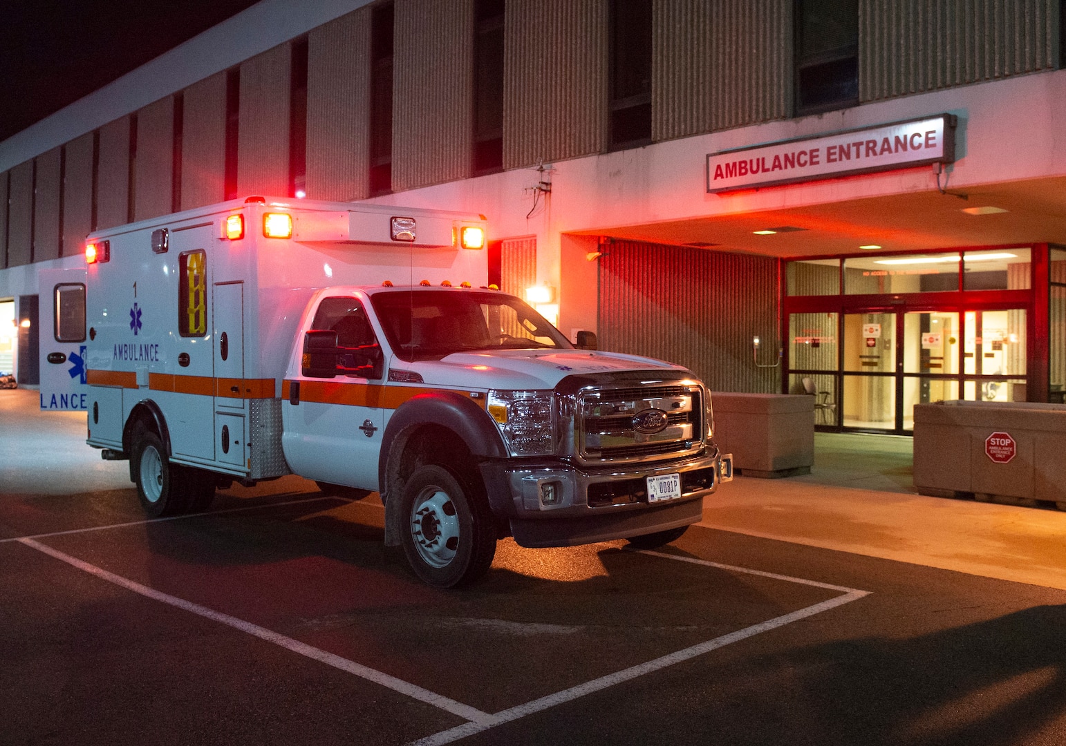 An ambulance sits with its lights on outside the Wright-Patterson Air Force Base, Ohio Medical Center, April, 28, 2021. The medical center is open 24 hours a day with medical personnel standing by to treat anyone that comes through their door. (U.S. Air Force photo by Wesley Farnsworth)