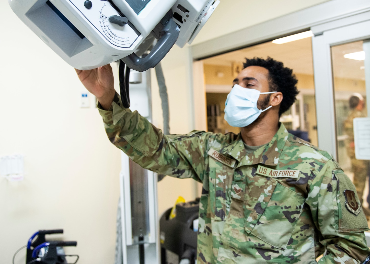 U.S. Air Force Senior Airman Jikhail Robinson, a radiologic technologist with the 88th Medical Group, takes a portable chest x-ray of a patient inside the emergency room of the Wright-Patterson Air Force Base, Ohio Medical Center, April, 28, 2021. The medical center is open 24 hours a day with medical personnel standing by to treat anyone that comes through their door. (U.S. Air Force photo by Wesley Farnsworth)
