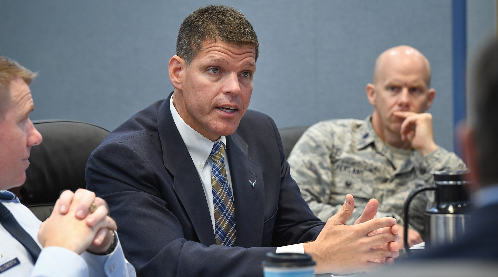 John Henderson, assistant secretary of the Air Force for Installations, Environment and Energy, speaks with Col. Chad Ellsworth, installation commander, left, Lt. Col. Ken Ferland, deputy commander, and others during a mission overview briefing at Hanscom Air Force Base, Mass., Aug. 28. During his visit, Henderson heard from base and Massachusetts Institute of Technology Lincoln Laboratory personnel about military construction projects on the installation and was briefed by the executive director of the Massachusetts Military Asset and Security Strategy Task Force. (U.S. Air Force photo by Todd Maki)