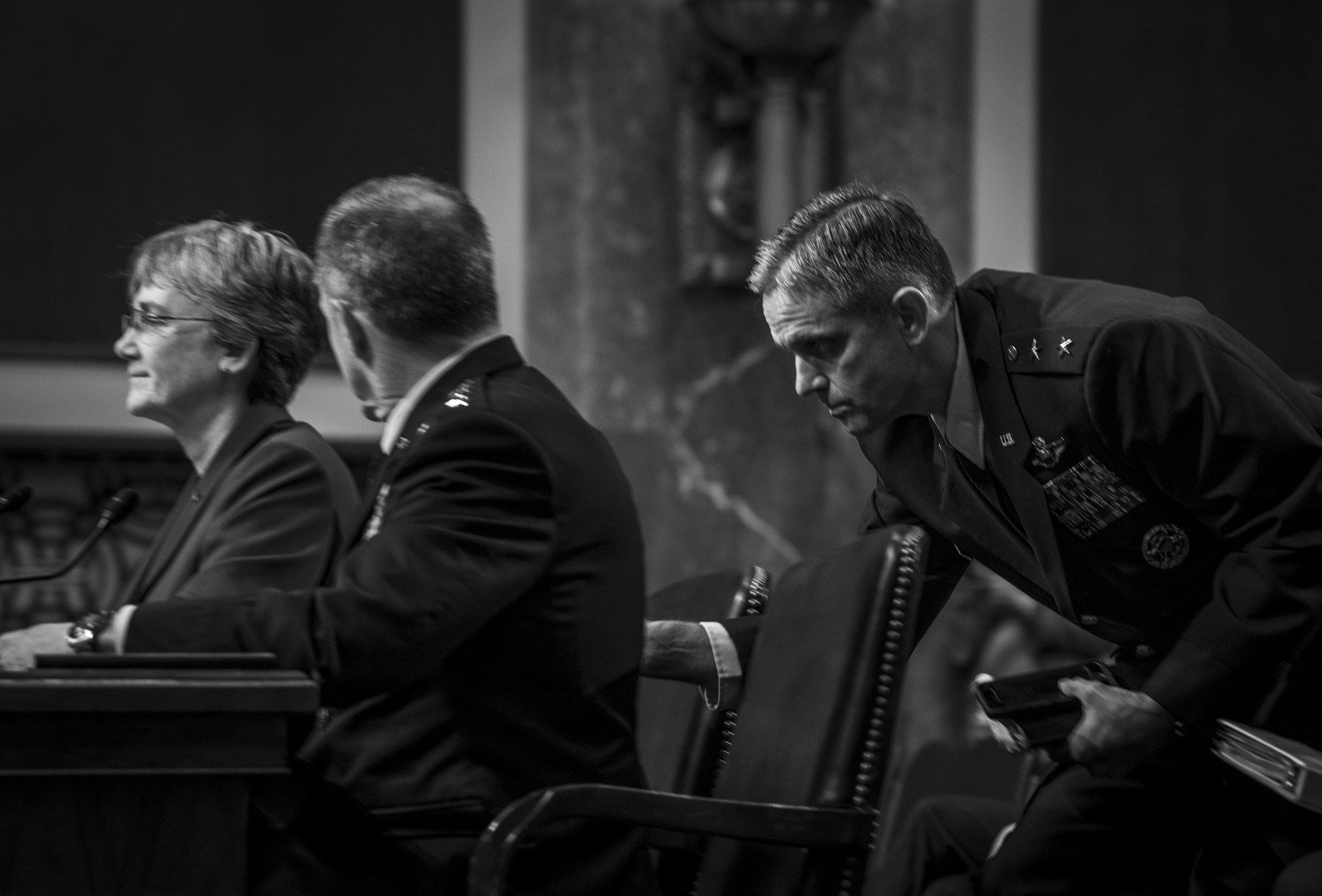 Maj. Gen. Steven Basham, director of the Secretary of the Air Force Legislative Liaison Office, hands a note to Gen. David Goldfein, U.S. Air Force chief of staff, during a posture hearing before the Senate Armed Services Committee at Dirksen Senate Office Building in Washington, D.C., April 4, 2019. (U.S. Air Force photo by Staff Sgt. Marianique Santos)