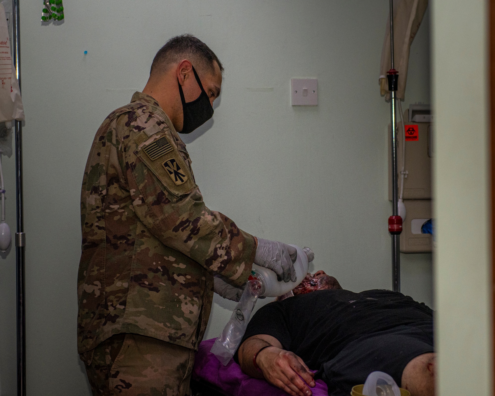 Soldier performs medial procedure on a simulated patient.