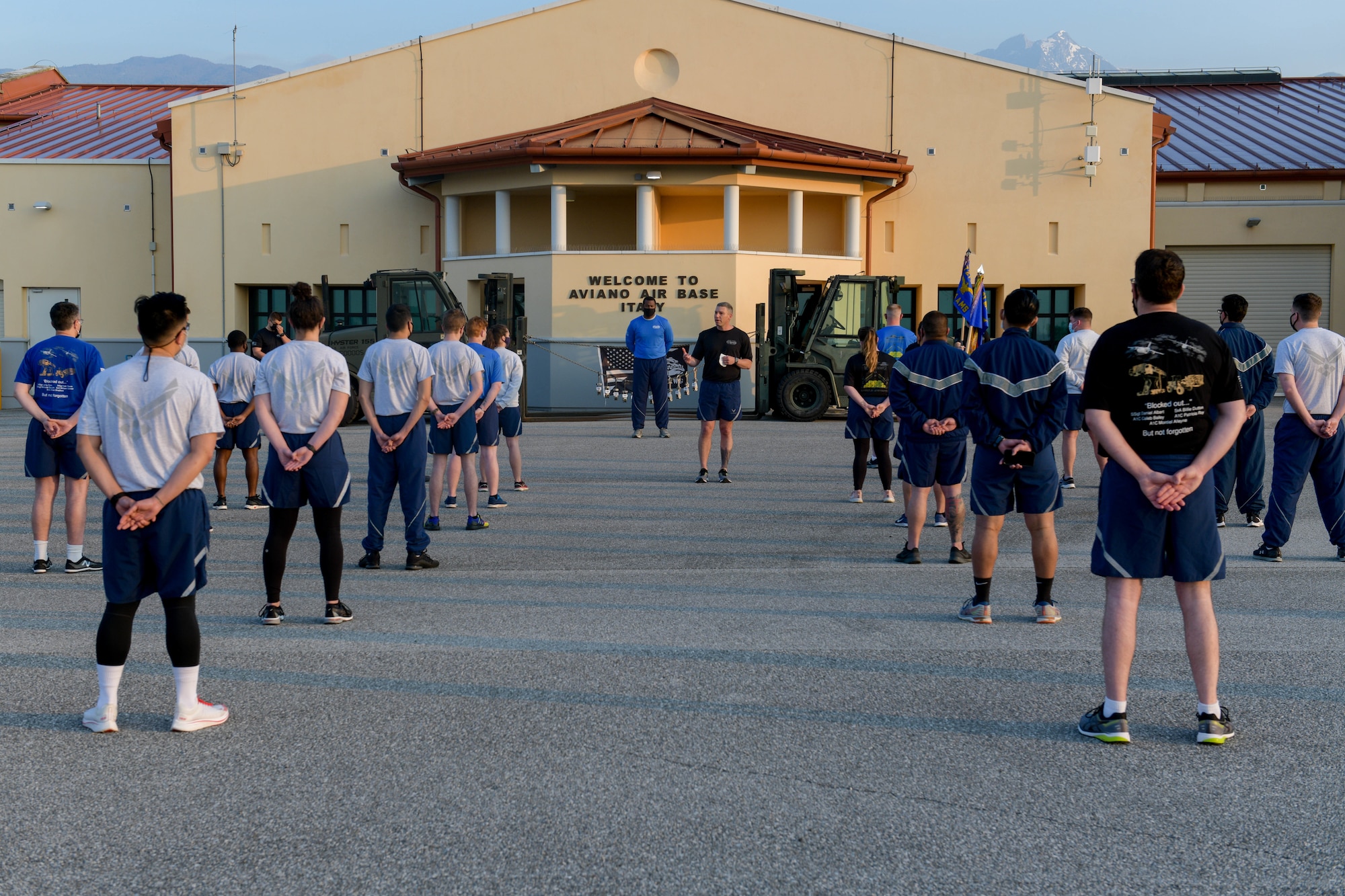 U.S. Air Force Senior Master Sgt. Timothy Okkerse, 724th Aircraft Maintenance Squadron superintendent, center, gives opening remarks before a ‘Port Dawg’ memorial run at Aviano Air Base, Italy, May 27, 2021. The ‘Port Dawg’ memorial run is an annual event which honors 12 fallen teammates from the career field with a 2.5 mile run. Port Dawgs are transportation specialists serving at aerial ports around the world. (U.S. Air Force photo by Airman 1st Class Brooke Moeder)