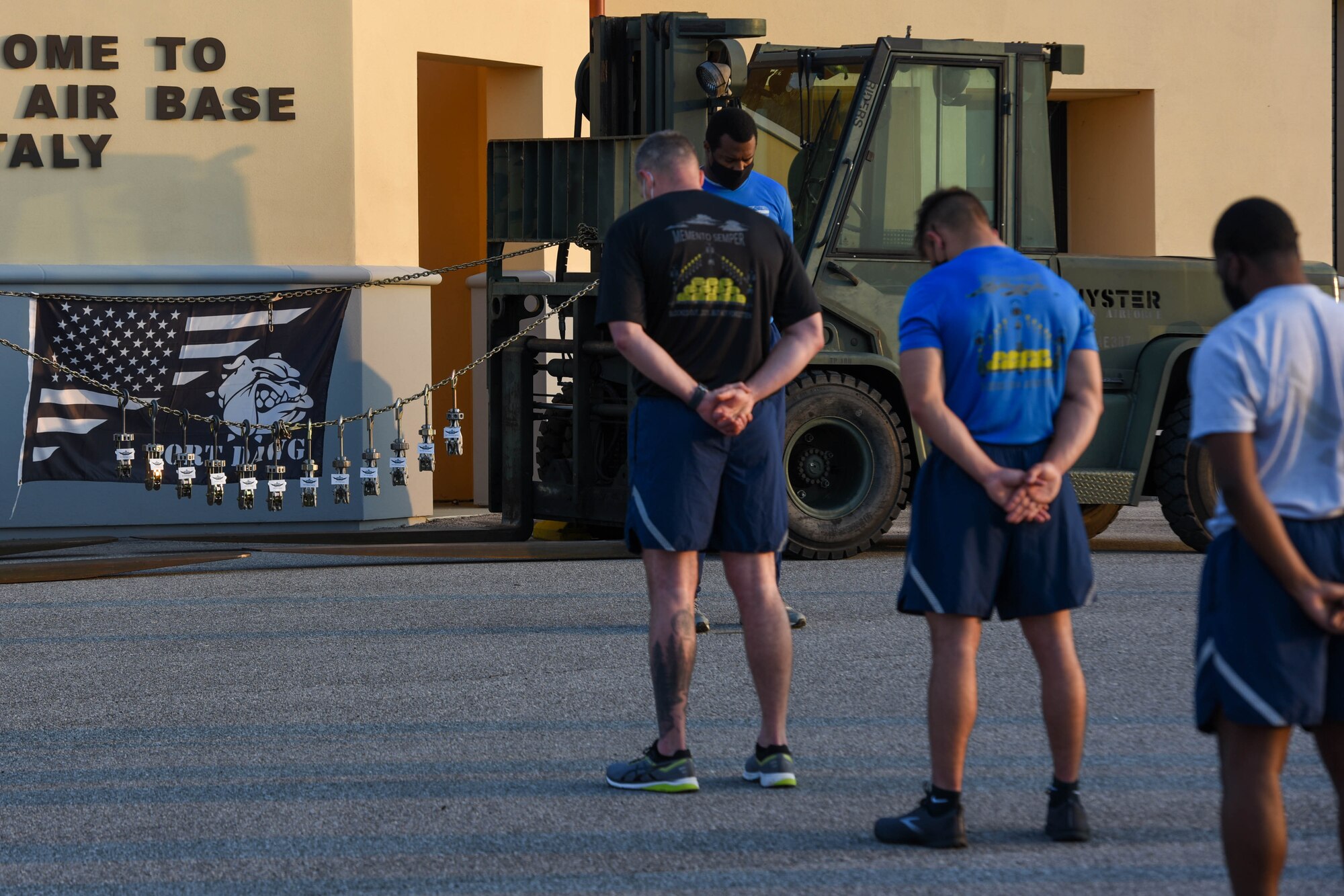 Members of the 724th Aircraft Maintenance Squadron observe a moment of silence before a ‘Port Dawg’ memorial run at Aviano Air Base, Italy, May 27, 2021. The run is held annually throughout the career field as a way to honor members who have fallen while serving as a ‘Port Dawg.’ The event is an opportunity to highlight the importance of the Port Dawgs in the AMS installations and community. (U.S. Air Force photo by Airman 1st Class Brooke Moeder)