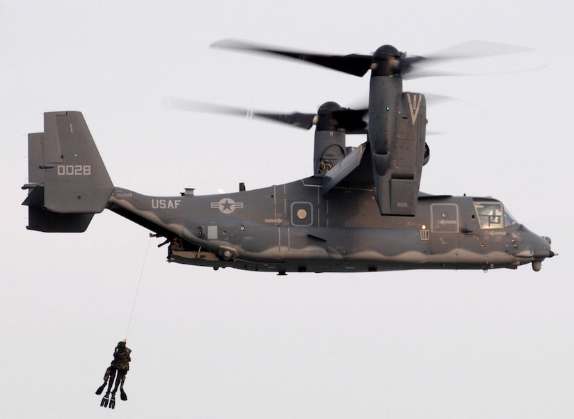 Two Navy Seals get hoisted up into a CV-22 Osprey during a training mission June 28.  The Osprey and aircrew are from the 8th Special Operations Squadron at Hurlburt Field, Fla.  ( U.S. Air Force photo/Senior Airman Andy M. Kin)
