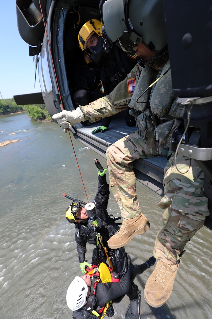 North Carolina National Guard Aviators join first responders from 16 state and local agencies for North Carolina helicopter aquatic rescue team training at Weldon, North Carolina, May 20, 2021. The training at the rapids of the Roanoke River simulated swift water rescue missions.
