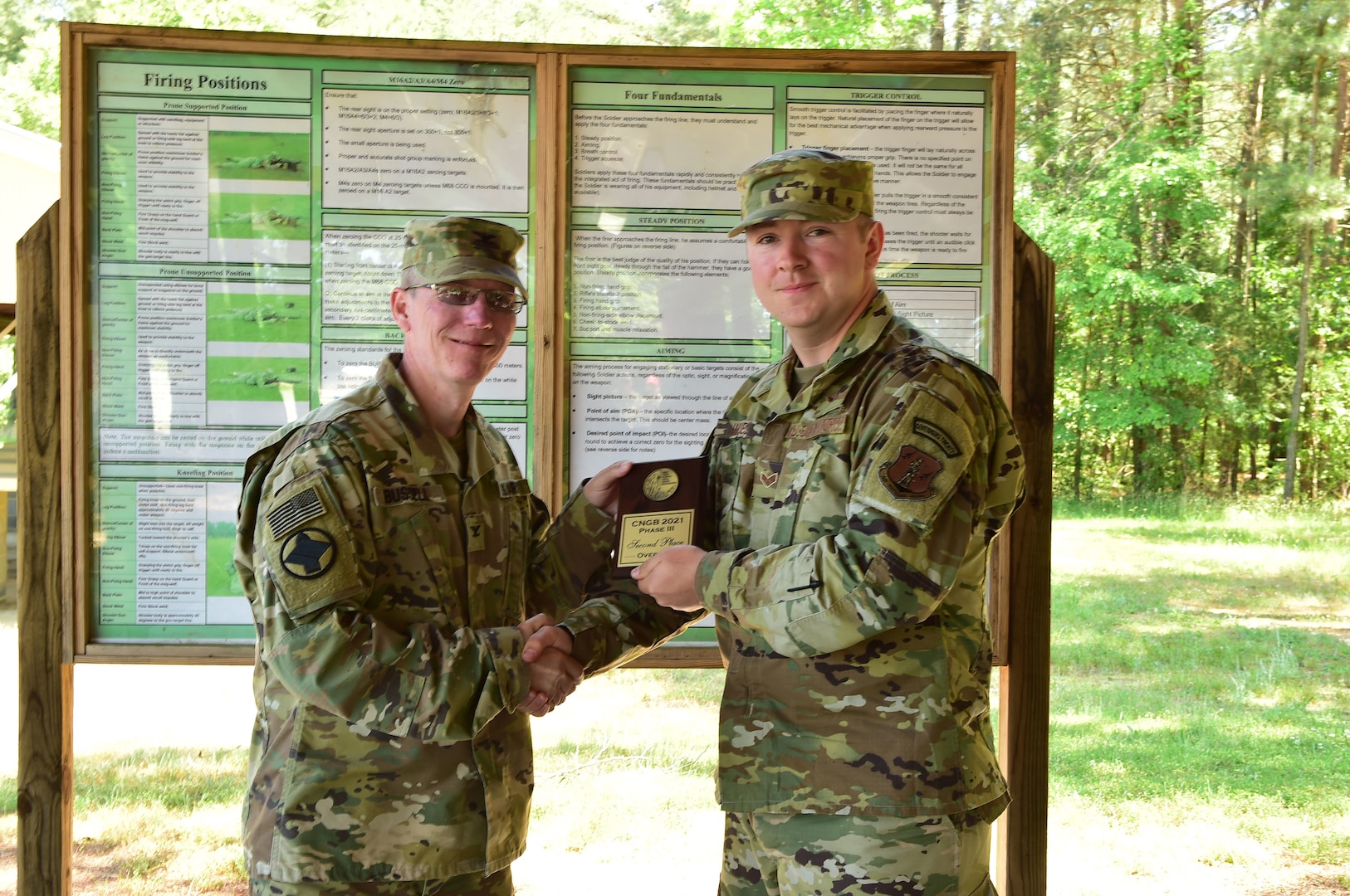 Senior Airman Andrew Jaques, Arkansas National Guard, was presented the overall second place aggregate champion plaque by Col. Andy Bussell, commander of the National Guard Marksmanship Training Center, at Camp Butner, Hampton, North Carolina, May 21, 2021. Jaques scored 2,767-37X during the 2021 Chief, National Guard Bureau Postal Matches.