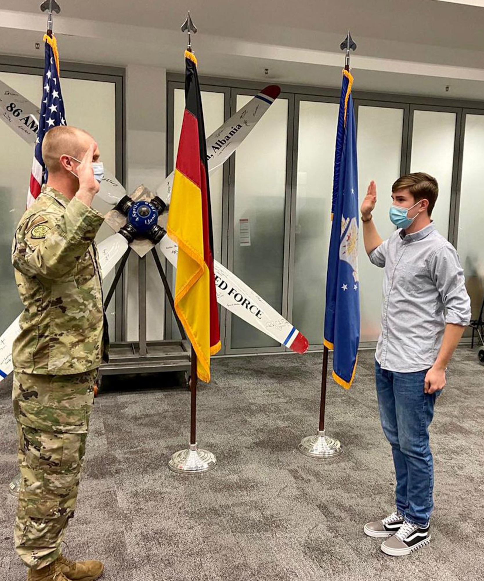 U.S. Air Force Lt. Col. Ryan Roper, 435th Contingency Response Support Squadron commander administers the oath of enlistment to Ethan Williams at Ramstein Air Base, Germany, May 17, 2021. Ethan is the fourth generation of his family to serve in the U.S. Armed Forces. As he begins his career, his father, Master Sgt. Daniel Williams, 435th CRSS air advisor operations superintendent, will retire. (Courtesy photo)