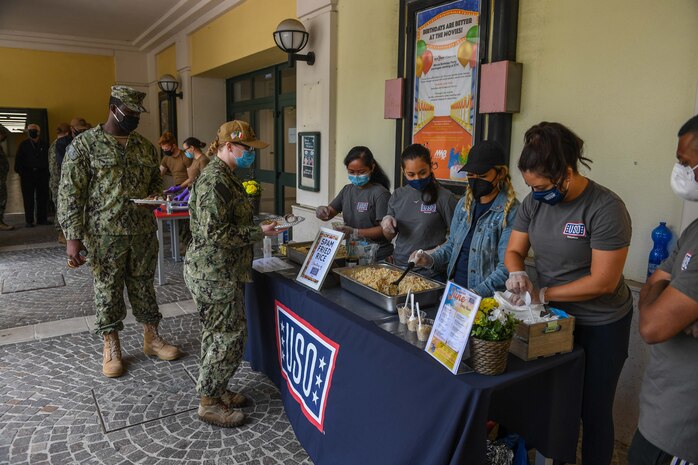 NAVAL SUPPORT ACTIVITY NAPLES, Italy (May 27, 2021) Naples USO volunteers serve food during a celebration in honor of Asian American Pacific Islander Heritage Month on Naval Support Activity Naples, Italy, May 27, 2021. U.S. Naval Forces Europe-Africa/U.S. Sixth Fleet, headquartered in Naples, Italy, conducts the full spectrum of joint and naval operations, often in concert with allied and interagency partners in order to advance U.S. national interests and security and stability in Europe and Africa. (U.S. Navy photo by Mass Communication Specialist 2nd Class Trey Fowler)