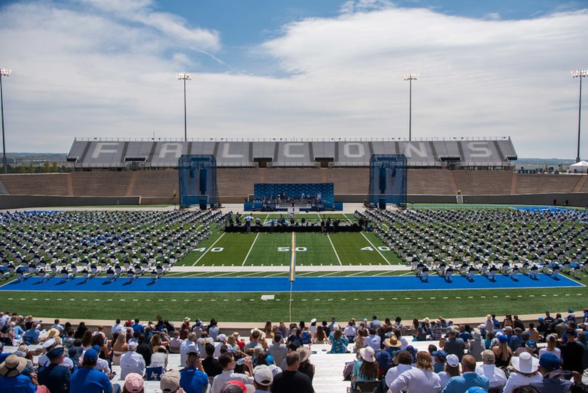 an areal photo of cadets standing in falcon stadium preparing to graduate