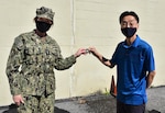 DLA Director presents coin to Minsoo Yoon.