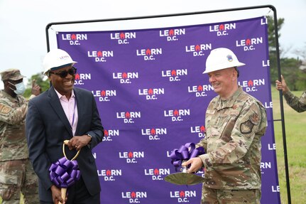 (Left) Mr. Greg White, chief executive of the LEARN network, and U.S. Air Force Maj. Gen. Ricky Rupp, Air Force District of Washington commander, share a laugh at the LEARN ground breaking ceremony at Joint Base Anacostia-Bolling, Washington D.C., April 29, 2021. LEARN D.C. is a new public charter school located on JBAB and open to all D.C. children in Fall 2021. (U.S. Air Force photo by Tech. Sgt. Corey Hook)