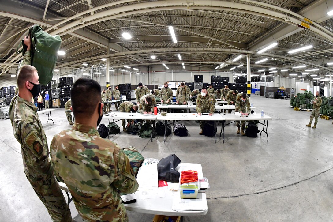 Senior Airman Austin Neri (left) and Senior Airman Jhon Espiritu, both with 75th Logistics Readiness Squadron, provide instruction during a joint inventory inspection of personal equipment during a mobility exercise May 26 at Hill Air Force Base, Utah. The exercise was to test deployment readiness of Airmen from the 75th Air Base Wing and 309th Aircraft Maintenance Group. (U.S. Air Force photo by Todd Cromar)