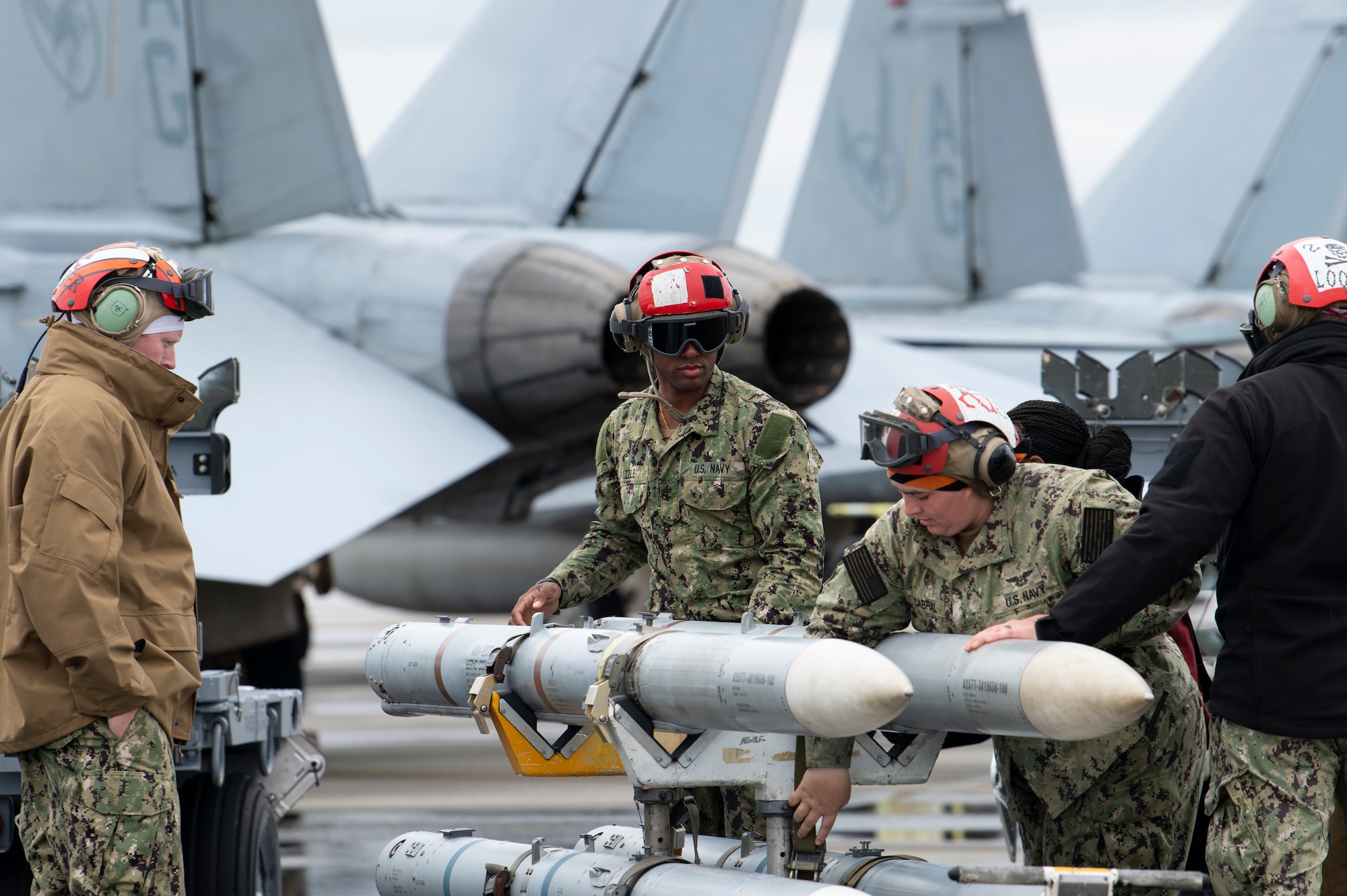 U.S. Navy Ordnancemen inspect missiles