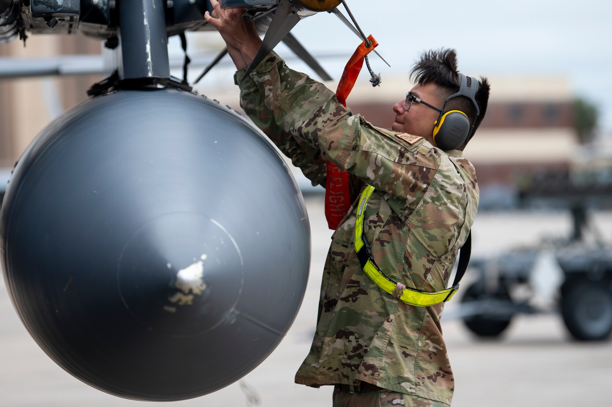 U.S. Air Force Airman secures missile onto aircraft