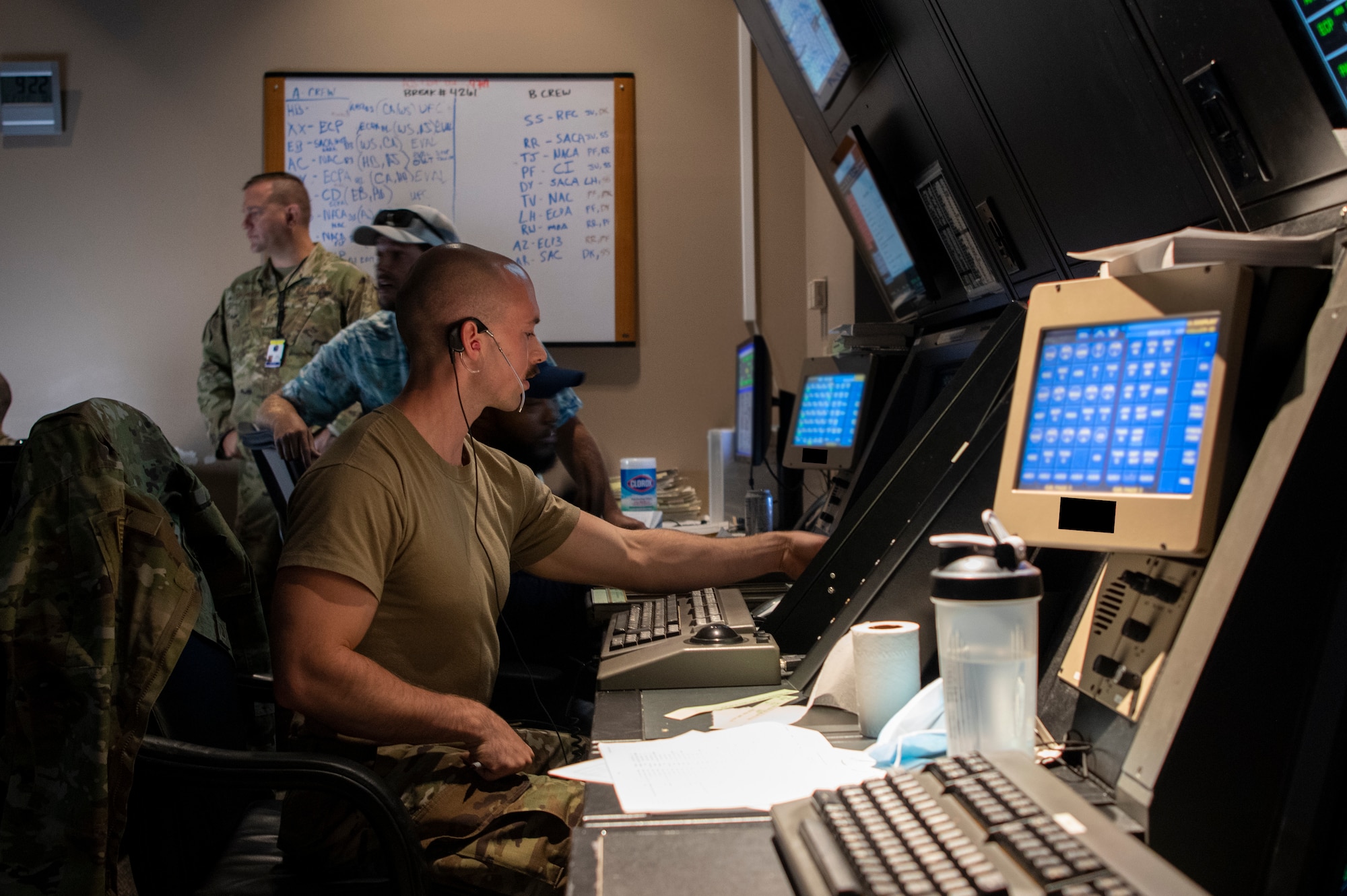 U.S. Air Force Airman sits in front of computer screens