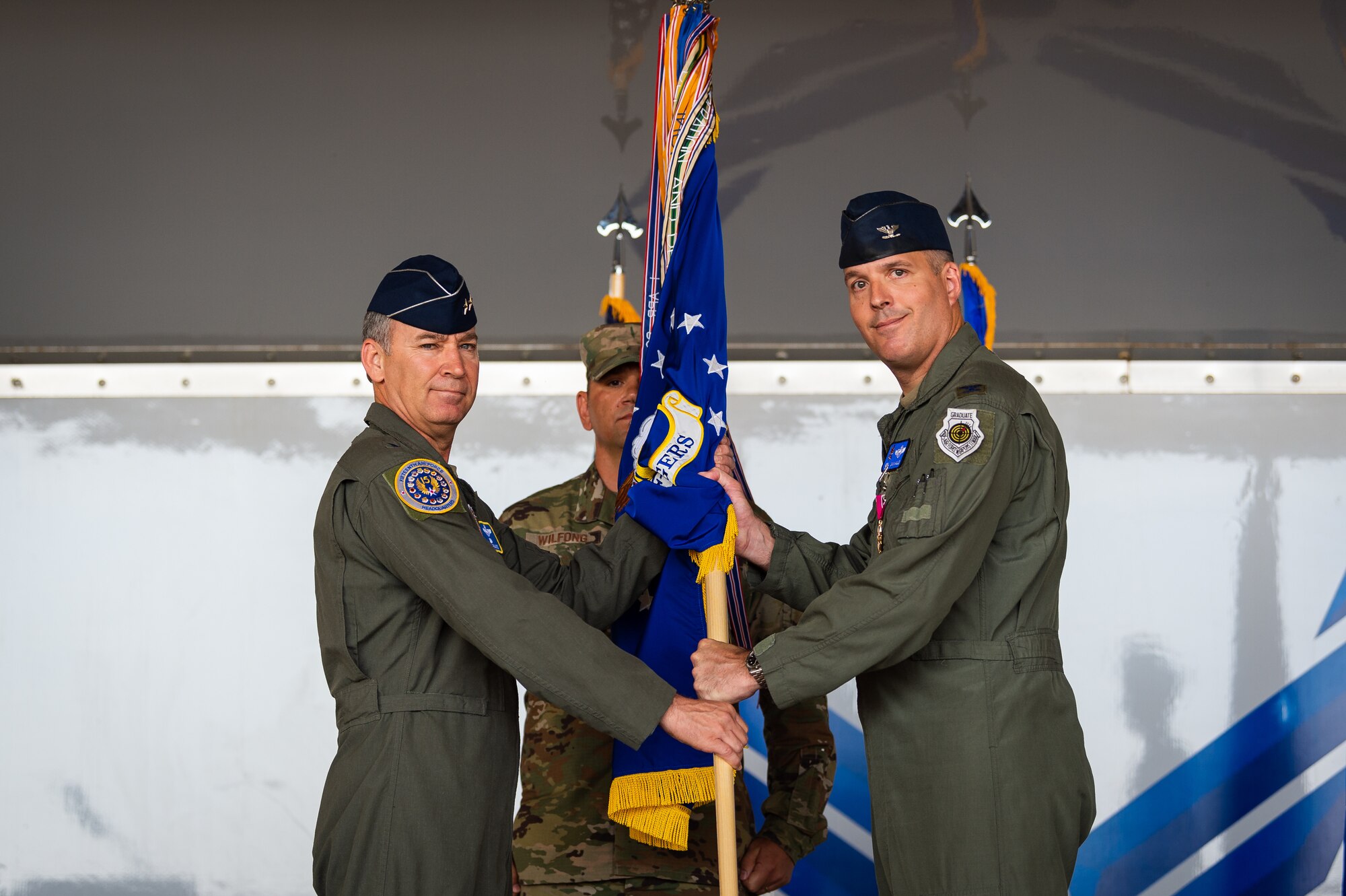 A photo of the 15th Air Force commander receiving a guidon from the former commander of the 23d Wing