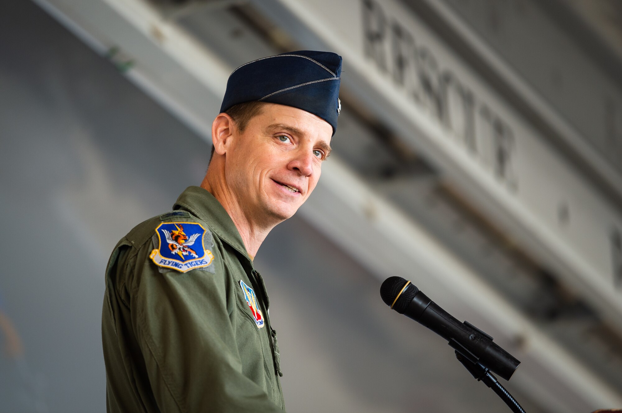 A photo of a commander speaking at a podium