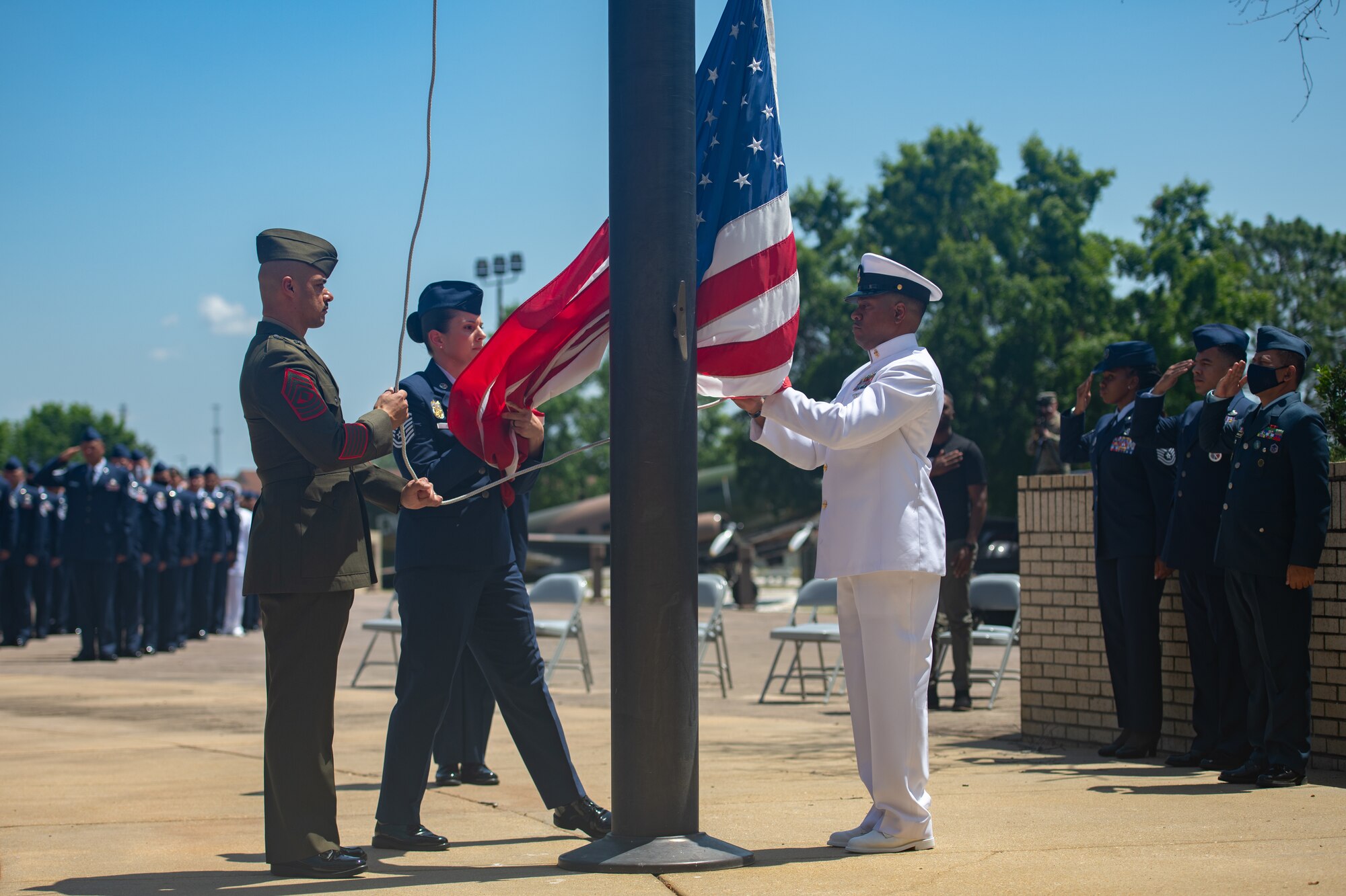 Graduates with Class 21-E lower the flag during a retreat ceremony after their graduation from the Senior Noncommissioned Officer Academy on Maxwell-Gunter Annex, Alabama, May 26, 2020. Retreat ceremonies serve a twofold purpose: they signal the beginning and ending of the official duty day and serve as ceremonies for paying respect to the flag and those who serve it.