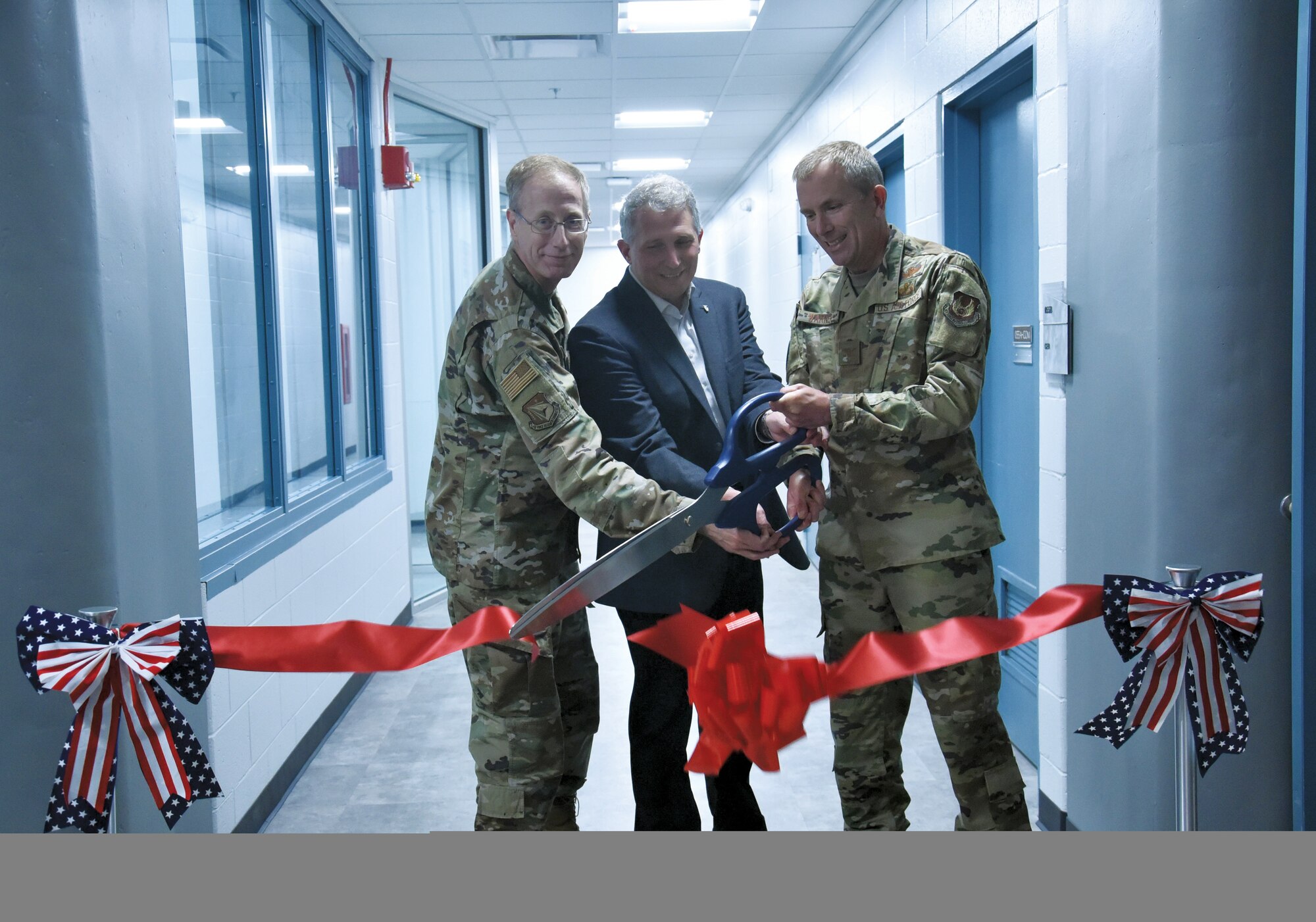 From left to right, AFRL Vice Commander Col. Paul Henderson, Materials and Manufacturing Directorate Chief Scientist Dr. Richard Vaia, and Deputy Director Col. Michael Warner cut the ribbon to open the renovated Materials Characterization Facility at Wright-Patterson Air Force Base. (U.S. Air Force photo/Spencer Deer)