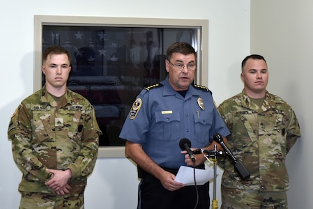 two soldiers presented with certificates.