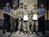 two soldiers presented with certificates.