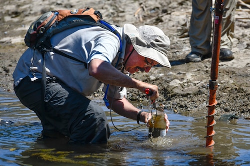 Mark Gard collects sediment samples