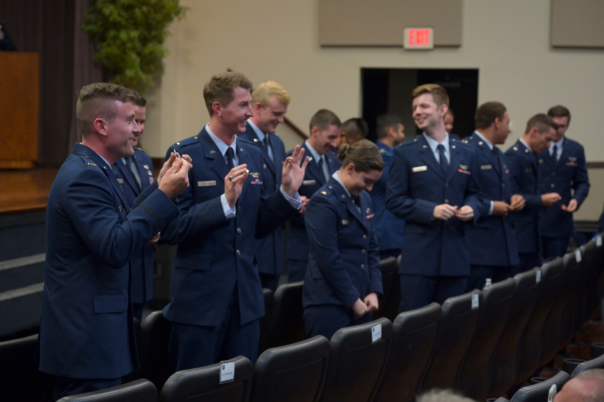 Graduates from Specialized Undergraduate Pilot Training Class 21-10 break their first pair of pilot wings, May 27, 2021, on Columbus Air Force Base, Miss. The pilot tradition entails snapping their first set of wings into two, never to be brought together again while the pilot is alive. One half is kept by the pilot, while the other half is kept by the pilot’s loved one. (U.S. Air Force photo by Senior Airman Jake Jacobsen)