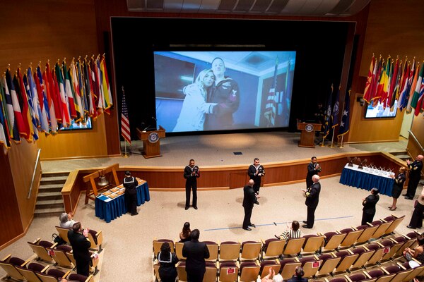 Adm. Christopher W. Grady, commander, U.S. Fleet Forces Command (USFFC), right center, and USFFC Fleet Master Chief Rick O�Rawe, left center, congratulate USFFC 2020 Shore Sailor of the Year (SOY) Naval Air Crewman, Helicopter 1st Class Chad Matthews, Helicopter Maritime Strike (HSM) Squadron 40, on screen, during a ceremony at the Joint Forces Staff College, May 27, 2021.