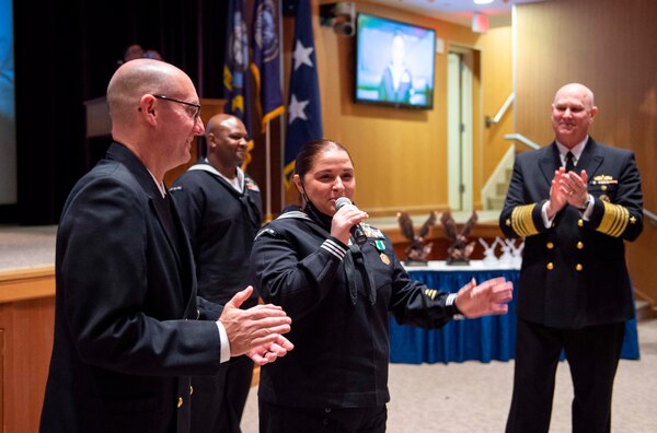 Adm. Christopher W. Grady, commander, U.S. Fleet Forces Command (USFFC), right, and USFFC Fleet Master Chief Rick O�Rawe, left, congratulate USFFC 2020 Sea Sailor of the Year (SOY) Personnel Specialist 1st Class Felicia Oxendine, Commander, Carrier Strike Group Ten, center, during a ceremony at the Joint Forces Staff College, May 27, 2021.