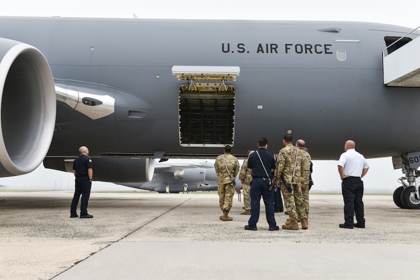 Members of the 87th Civil Engineer Squadron fire department gather around a KC-46 Pegasus during familiarization training at Joint Base McGuire-Dix-Lakehurst, N.J., May 26, 2021. The Joint Base expects to receive its first KC-46 sometime this year. (U.S. Air Force Photo by Senior Airman Shay Stuart)