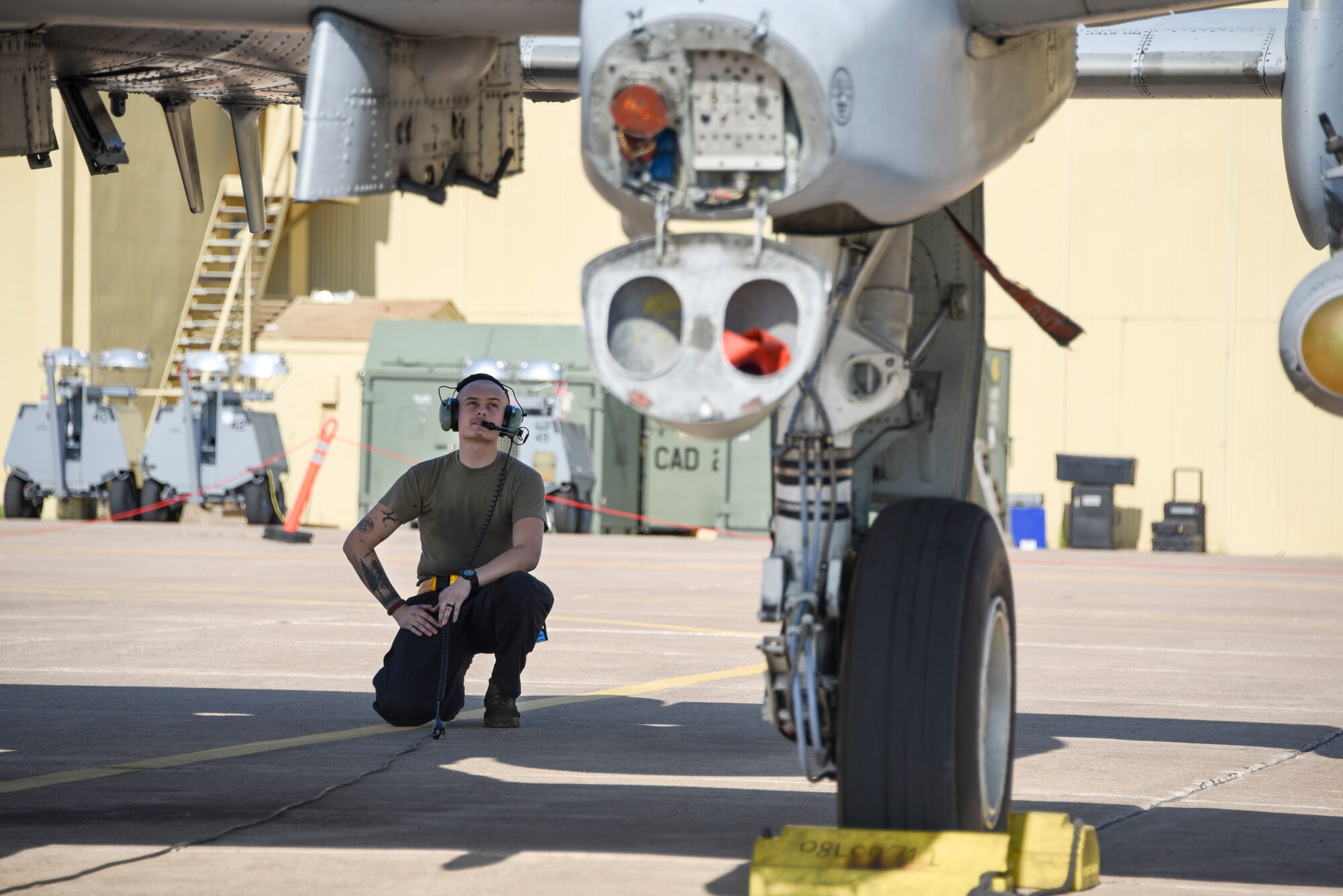 Crew chief inspects the underside of an A-10