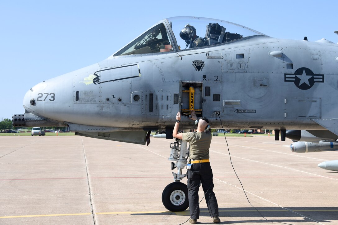 Crew chief closes the ladder hatch on an A-10